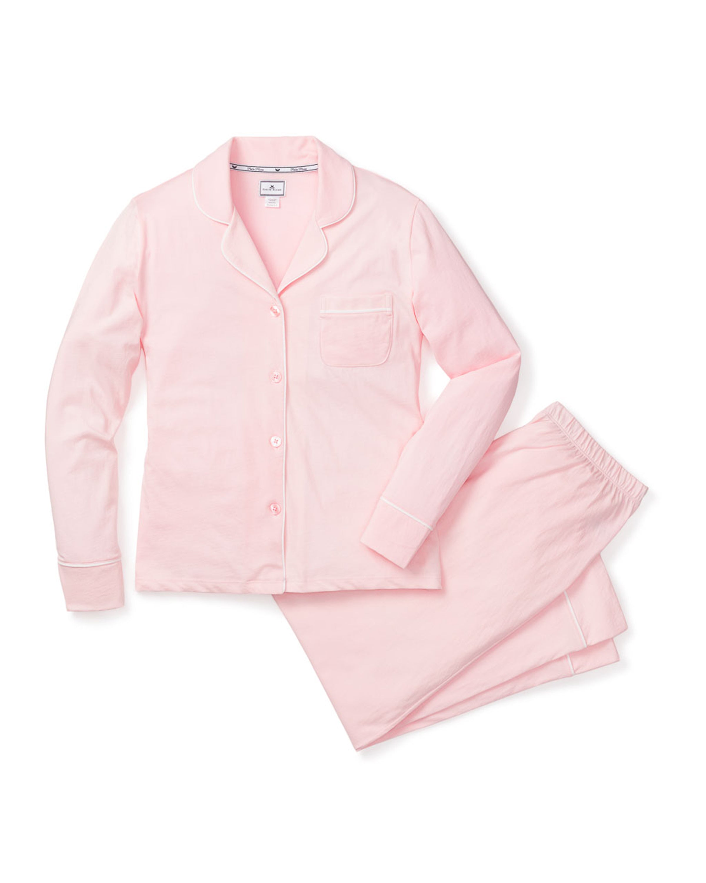 The Womens Pima Pajama Set in Pink by Petite Plume features a soft Peruvian Pima cotton ensemble with a long-sleeve button-up top, chest pocket, matching pants, and white piping, displayed on a white background.
