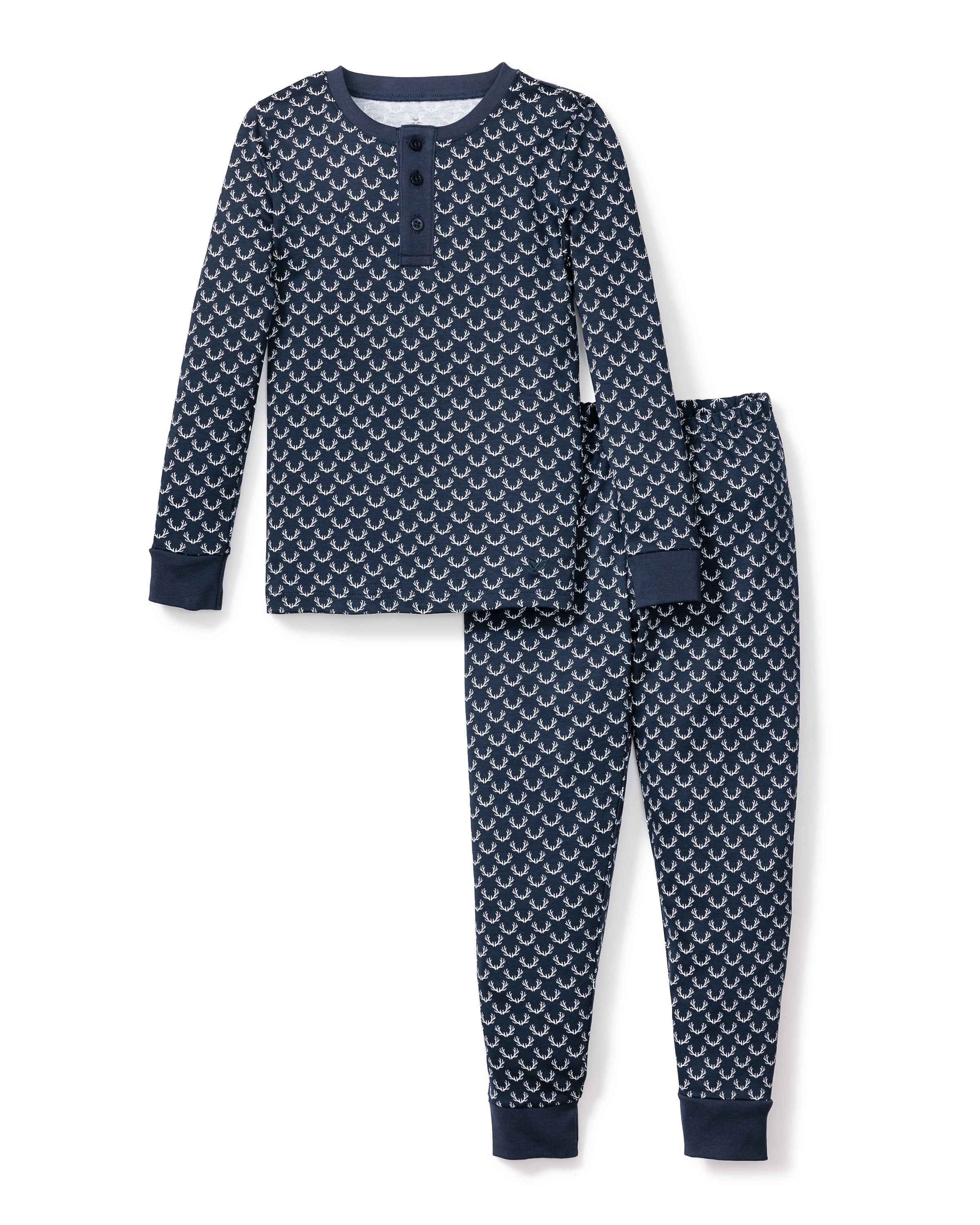 The Kids Pima Snug Fit Pajama Set Nordic Antlers by Petite Plume is crafted from soft Pima cotton in navy blue, showcasing a wave pattern in white. The long sleeve top features a henley neckline with three buttons, while the pants have an elastic waistband and ankle cuffs for comfort.