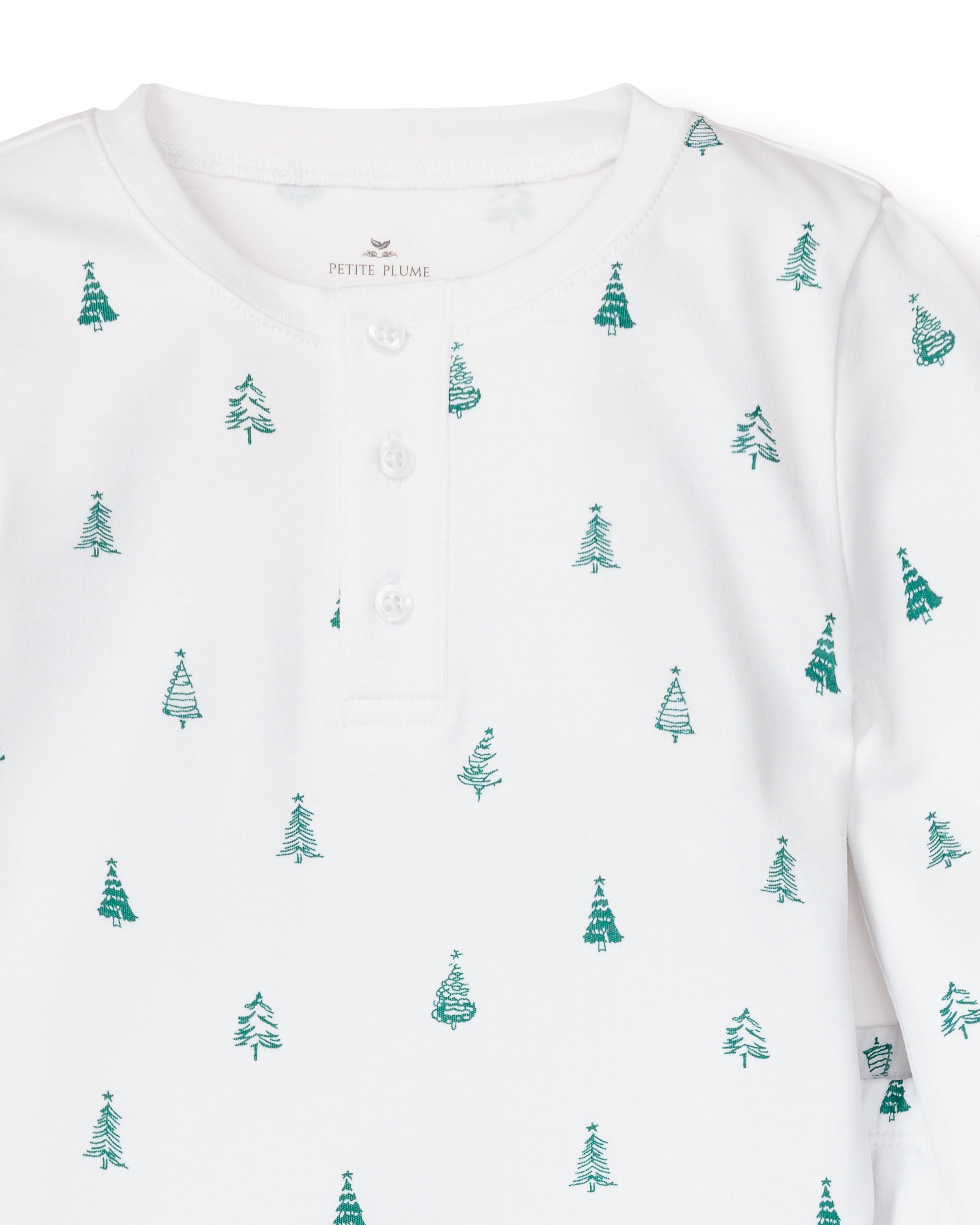 The Kids Pima Snug Fit Pajama Set in Evergreen Trees by Petite Plume is a white henley shirt crafted from soft Pima cotton, featuring small green Christmas trees and three neckline buttons for comfort.