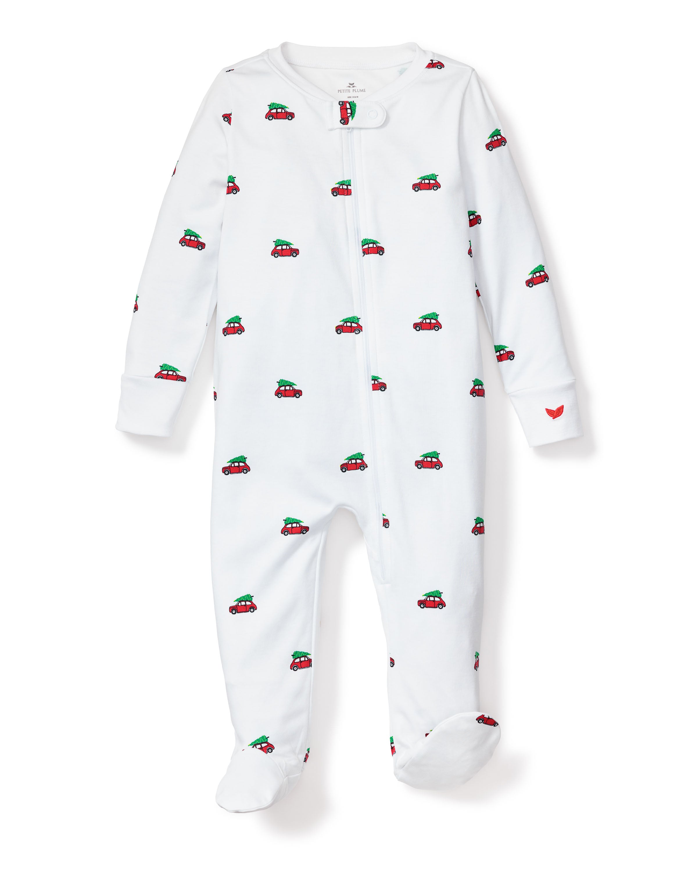 The Holiday Journey Pima Romper by Petite Plume is a cozy white baby onesie with a front zipper, featuring a delightful pattern of red and green cars. It has closed sleeves and feet, with a small red heart on the left sleeve—ideal sleepwear for children.