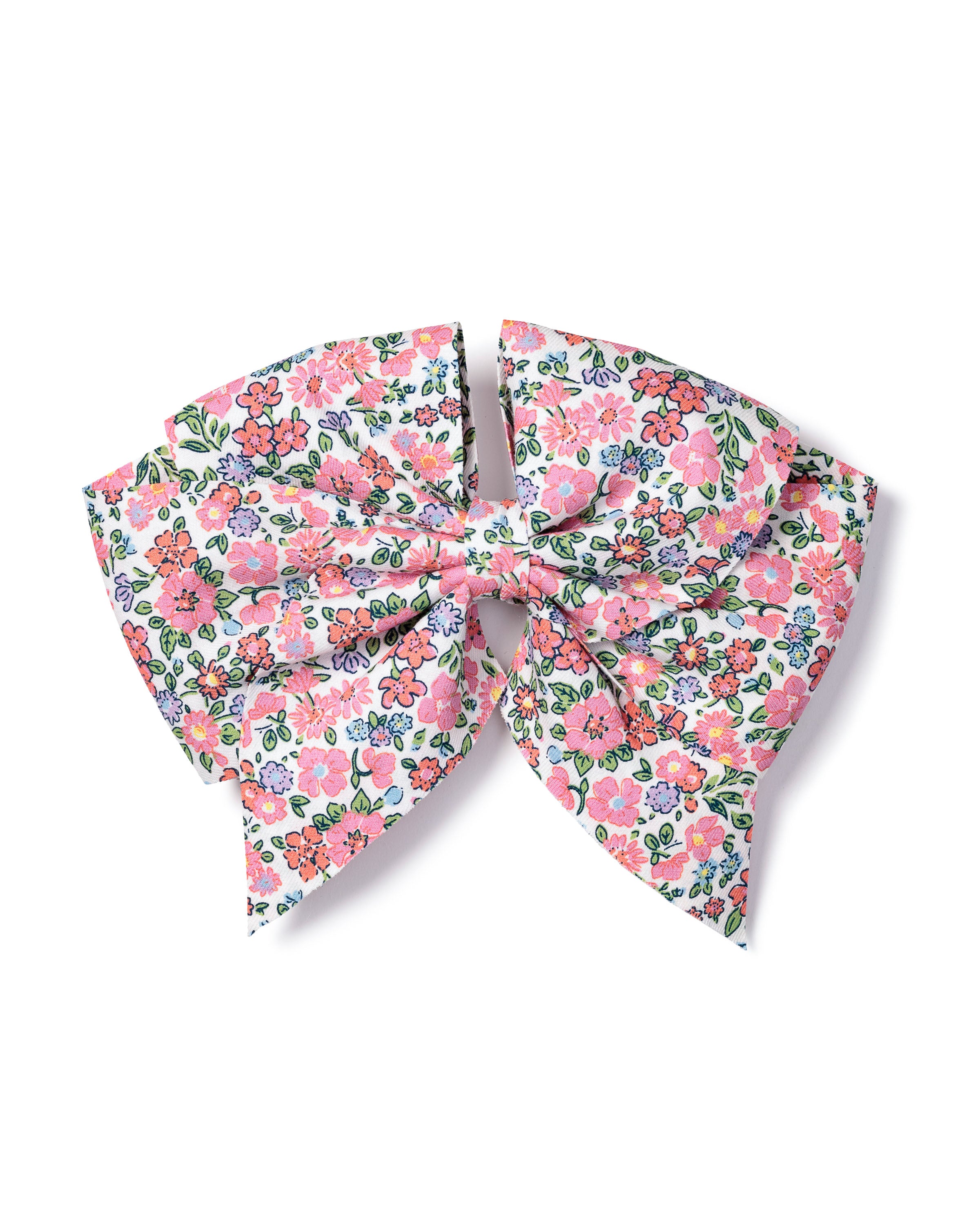 The Girls Hair Bows in Fleurs de Rose by Petite Plume features a large bow made of charming fabric with a colorful floral pattern of pink, orange, yellow, and green flowers on white—perfect for any girls hair accessory collection.