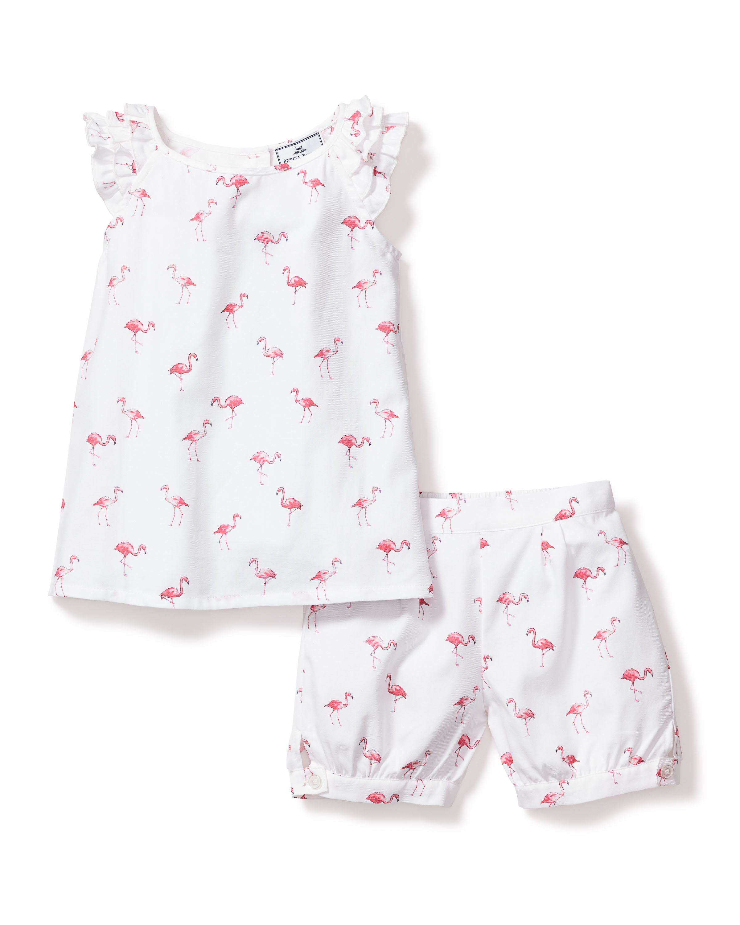 The Girls Twill Amelie Short Set in Flamingos by Petite Plume is a white sleeveless outfit ideal for pajama time, featuring a top with ruffled shoulders and matching shorts adorned with playful pink flamingos.