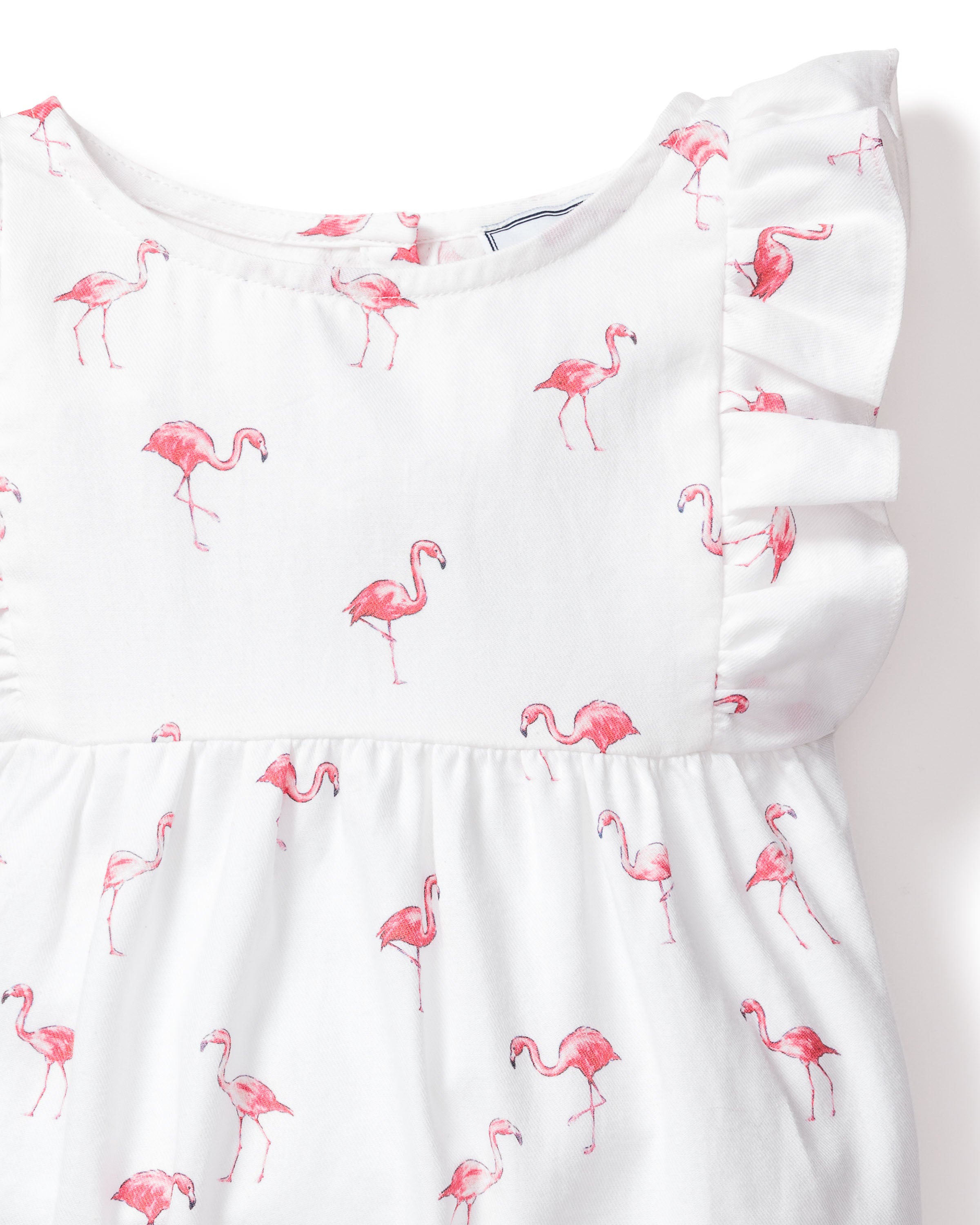 The Babys Twill Ruffled Romper in Flamingos by Petite Plume is a luxurious cotton pajama featuring ruffled sleeves and a tropical pink flamingo pattern.