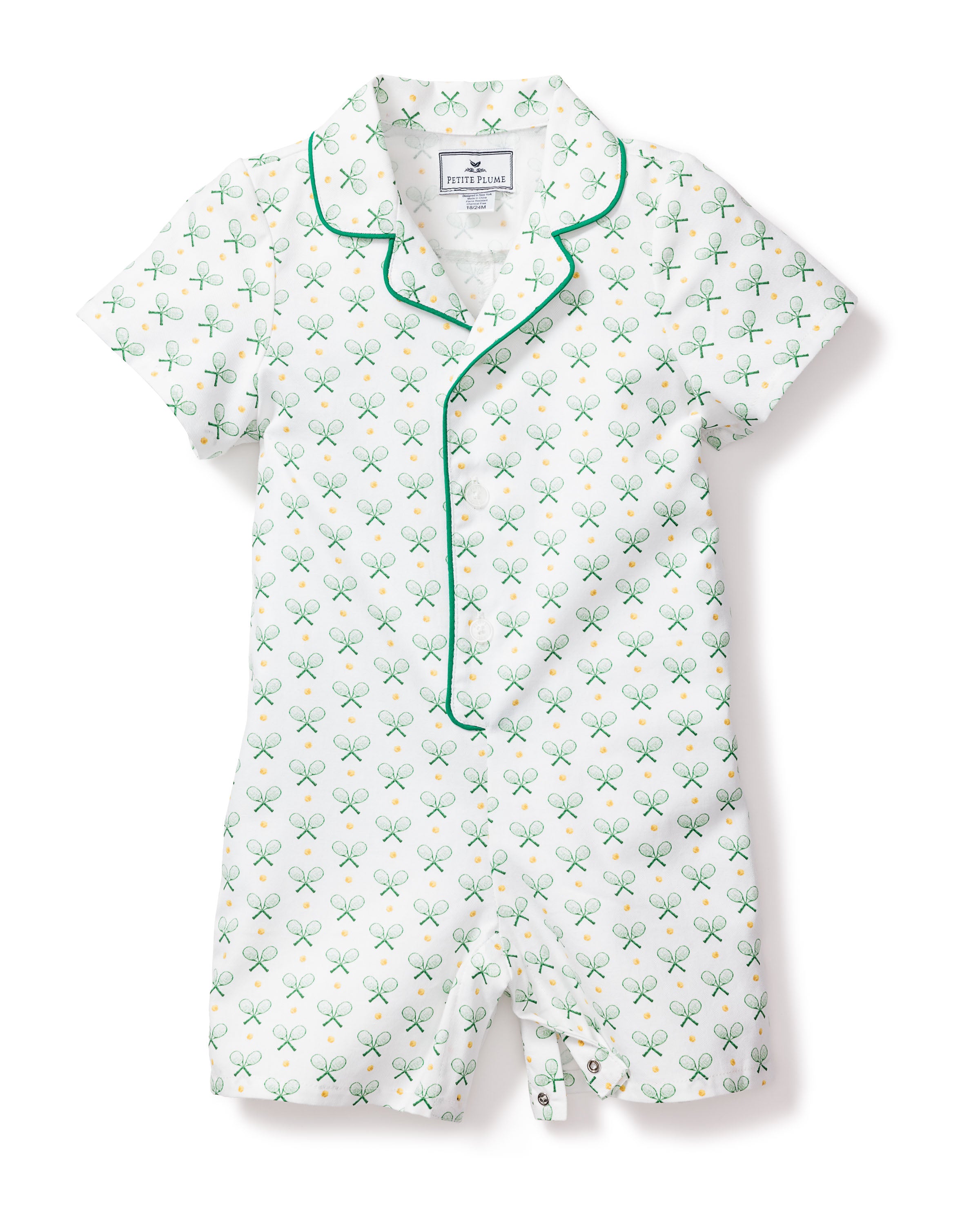 Petite Plumes Babys Twill Summer Romper in Match Point is a short-sleeve one-piece for children with a tennis racket and ball pattern. It features a button-up front, green piping, and luxurious white cotton fabric with green and blue designs.