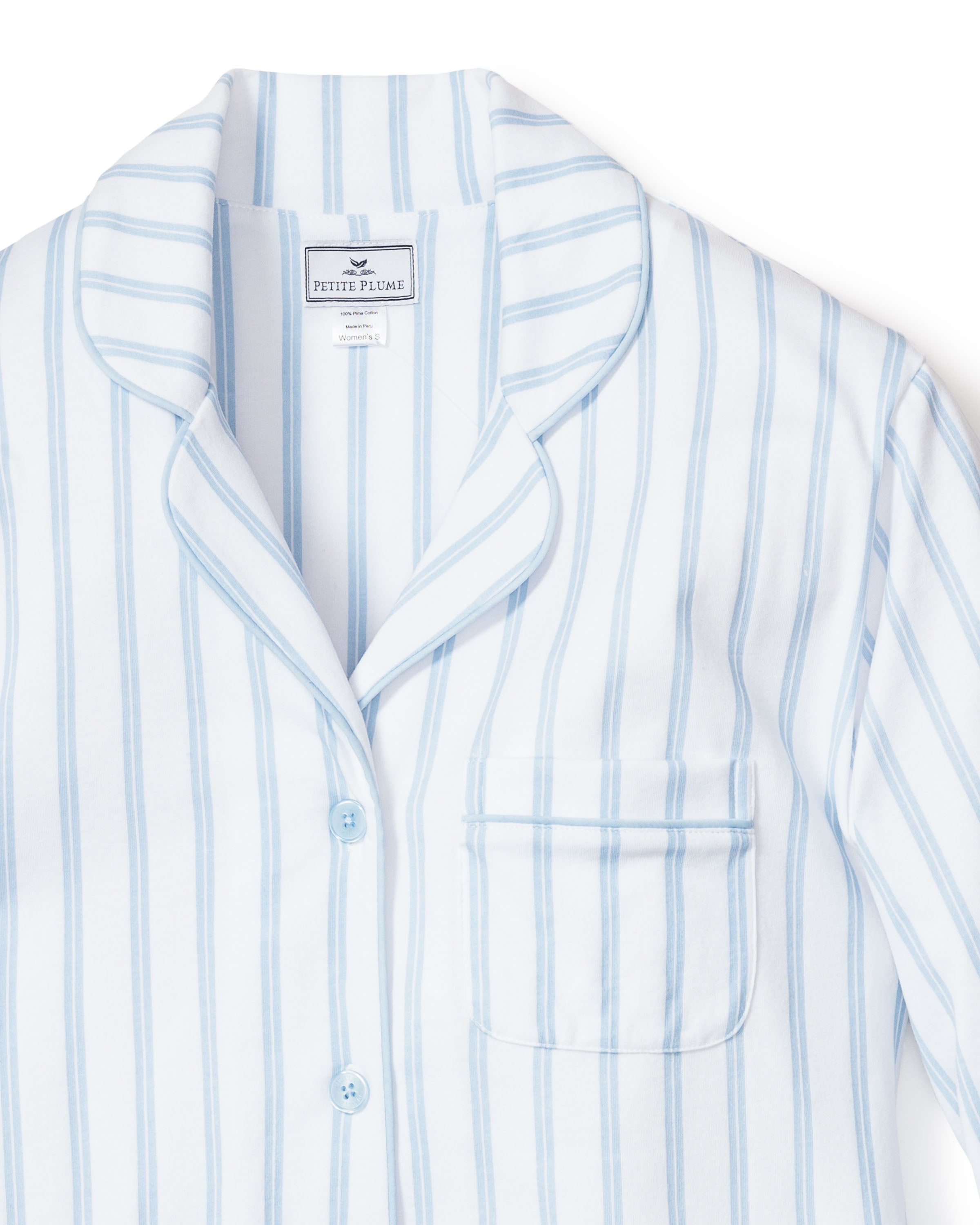 A close-up of Petite Plumes Womens Pima Pajama Set in Periwinkle and White Stripe, featuring a collared, button-down top with front pocket. Made from soft Pima cotton, its perfect for those who love luxurious sleepwear.