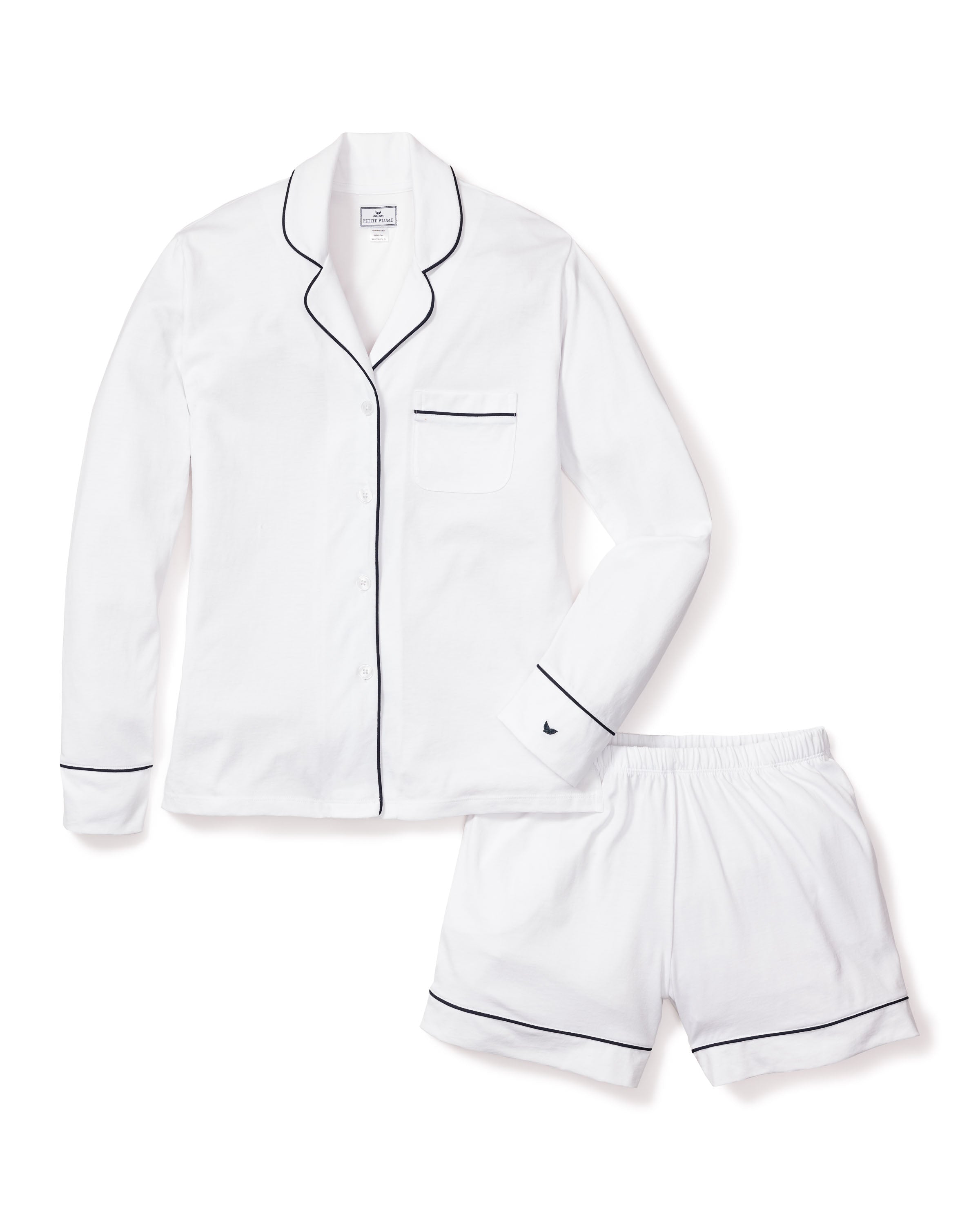 The Womens Pima Long Sleeve Short Set by Petite Plume in white with navy piping includes a button-up shirt with a chest pocket and matching shorts, all crafted from soft Pima cotton for luxurious sleepwear.