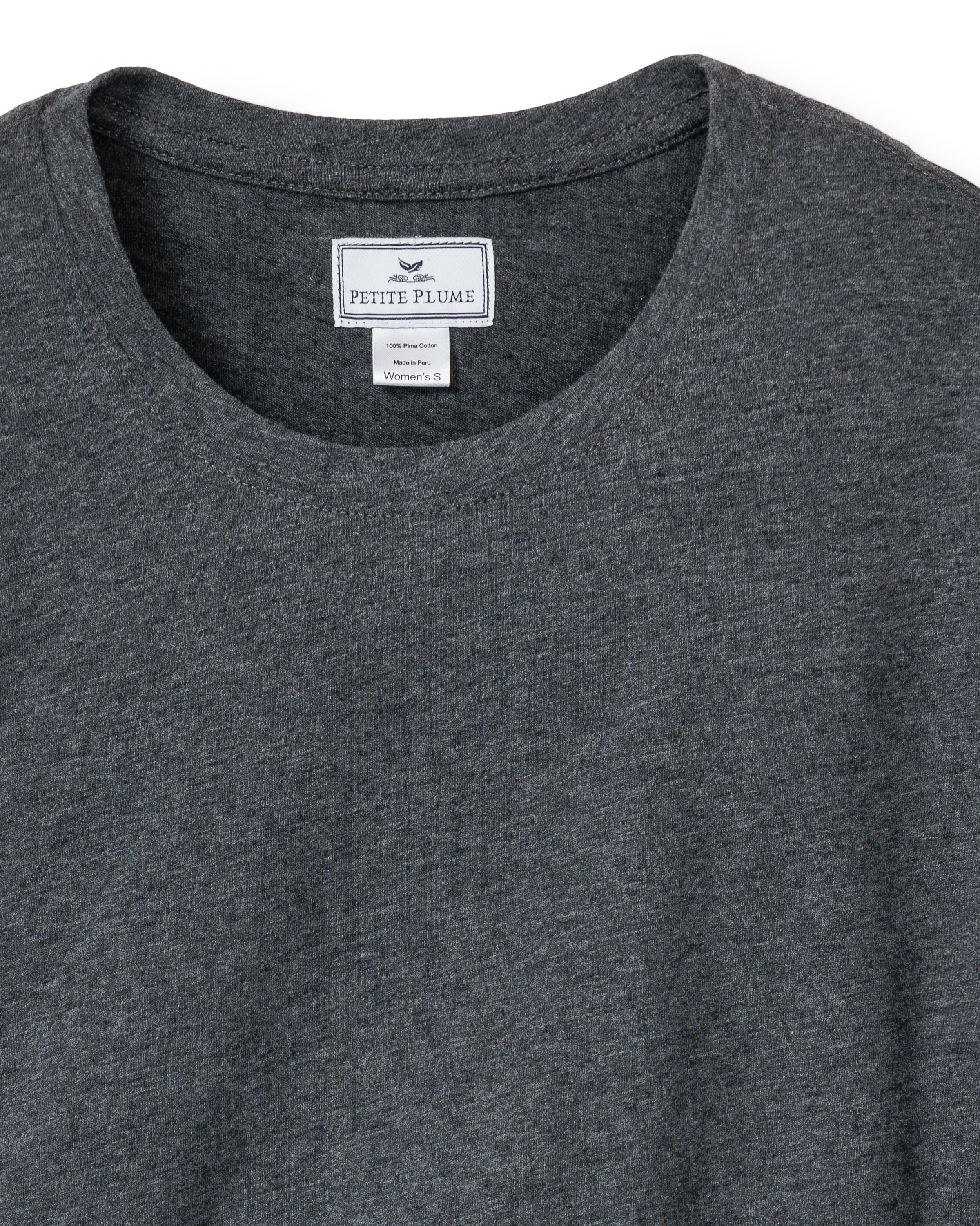 A close-up of a Petite Plume Womens Pima Long Sleeve Top in Dark Heather Grey reveals a round neckline with a label indicating its size small. Made from Peruvian Pima cotton, the fabric is soft and slightly textured, perfect for luxurious pajamas.