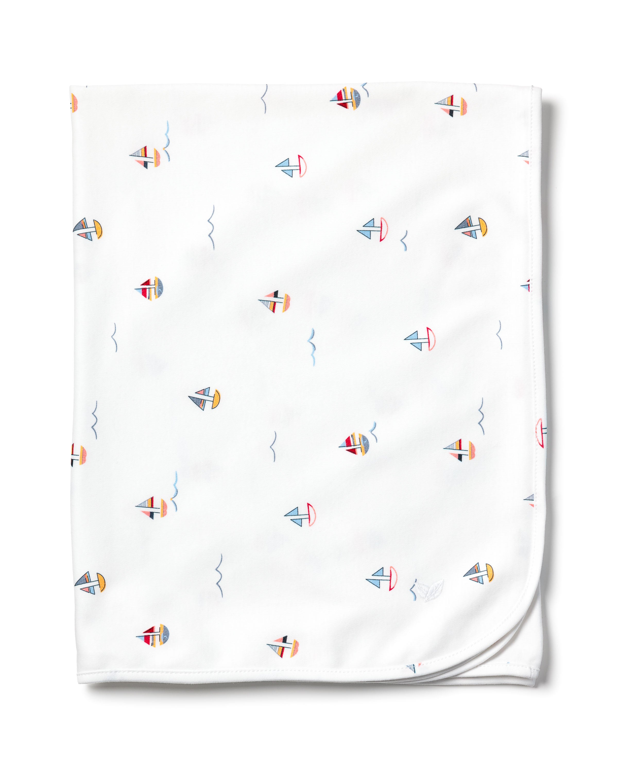 The Pima Baby Blanket in Bateau by Petite Plume is crafted from soft Peruvian Pima Cotton, featuring a charming pattern of small red, blue, and yellow sailboats scattered with wave-like lines. Its rounded corners offer a gentle touch.