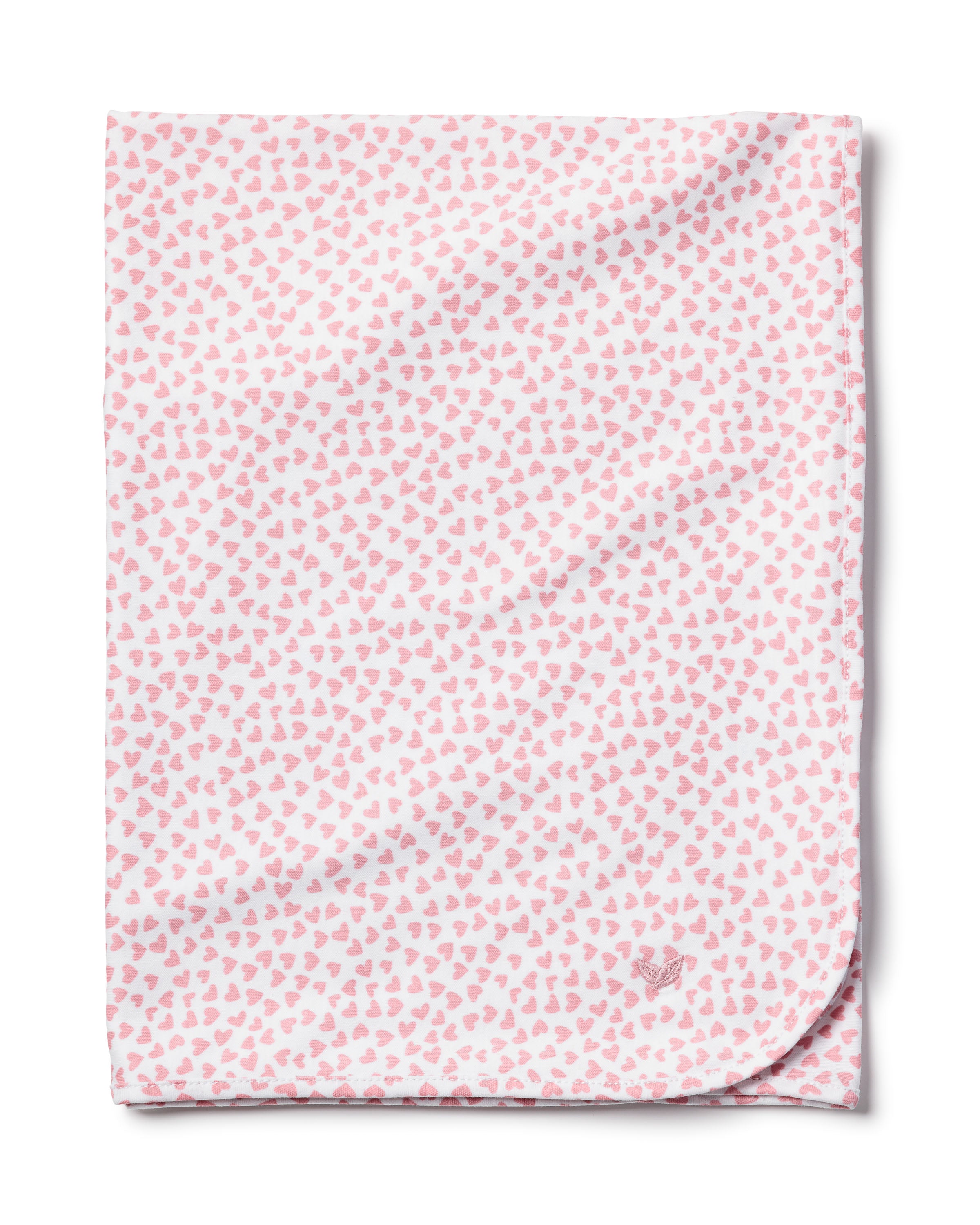 The Petite Plume Pima Baby Blanket in Sweethearts is a soft, white blanket made from luxurious Peruvian Pima Cotton. It features a pattern of small pink hearts, and a subtle outline of a small animal in one corner, adding both comfort and charm for your little one.
