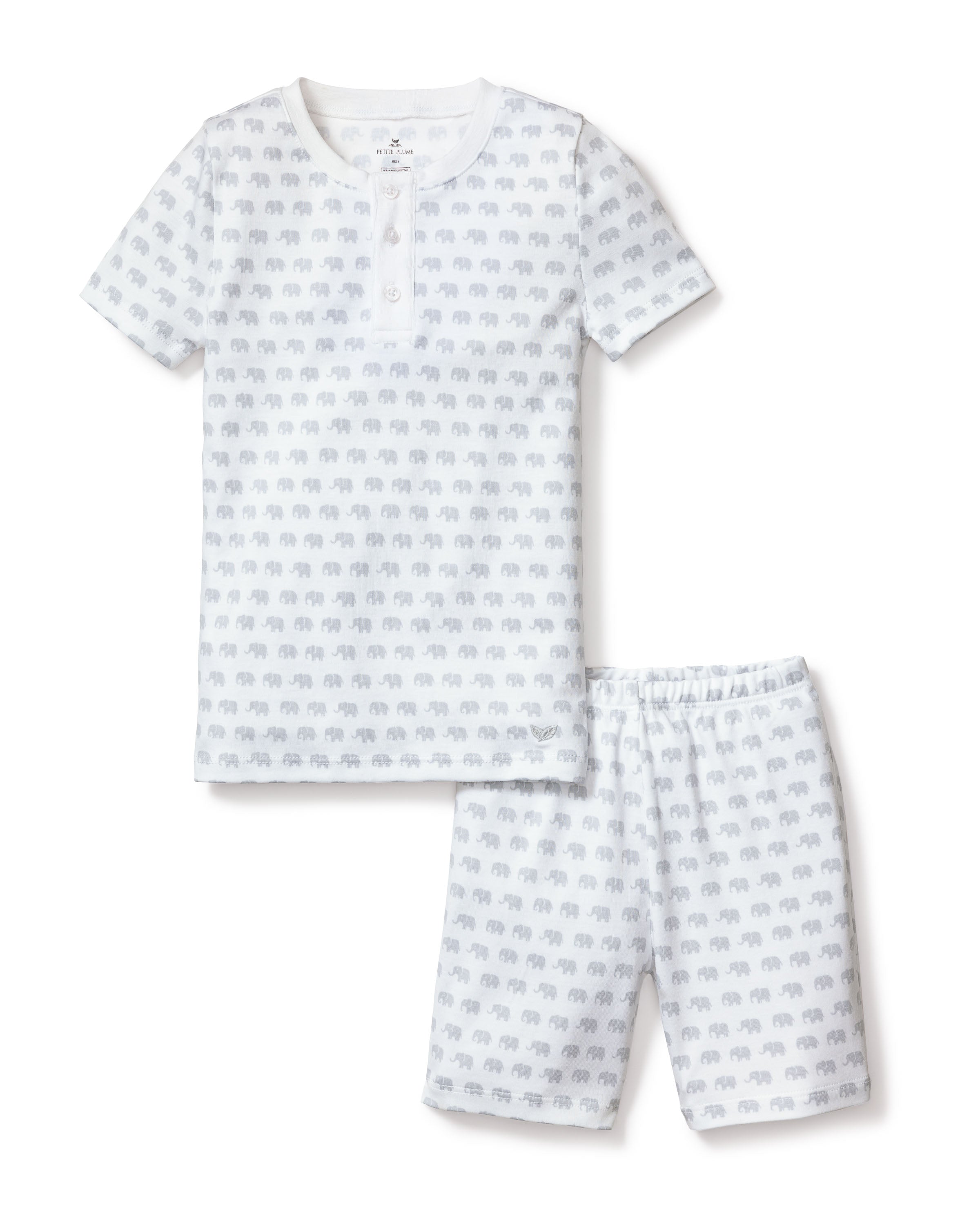 The Kids Pima Snug Fit Pajama Short Set in Grey Elephants by Petite Plume is a luxurious sleepwear option made from soft Pima cotton. These white pajamas feature playful grey elephant patterns and include short sleeves and shorts for comfortable nights.