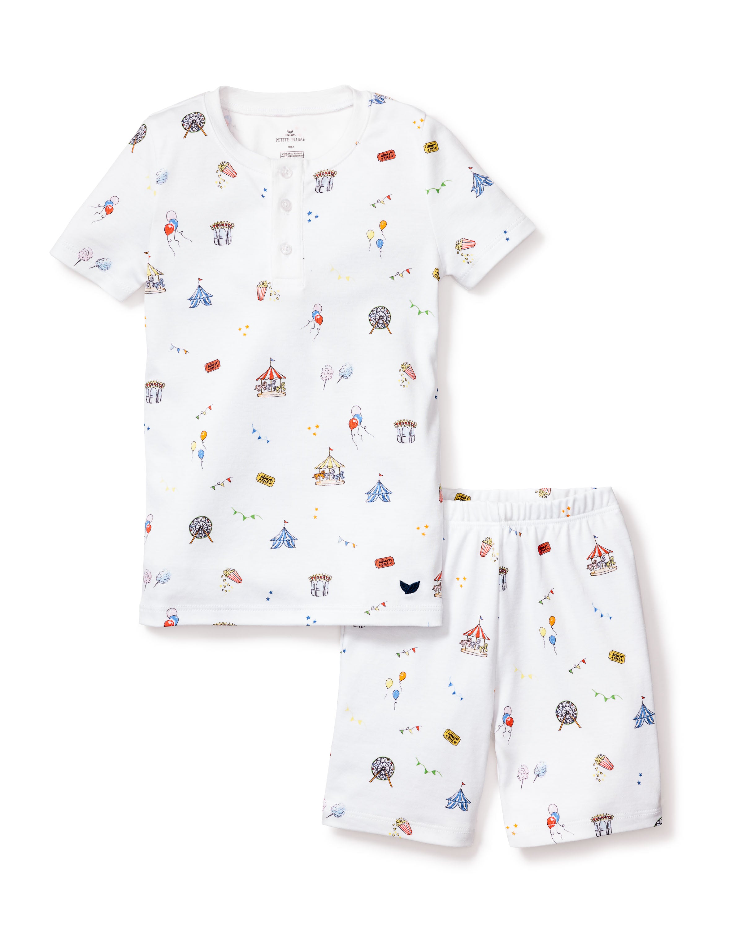 The Kids Pima Snug Fit Pajama Short Set in Carnival Memories by Petite Plume features a lively carnival-themed print with tents and balloons. The short-sleeved white top with a front button closure pairs elegantly with matching shorts for playful and comfortable sleepwear.