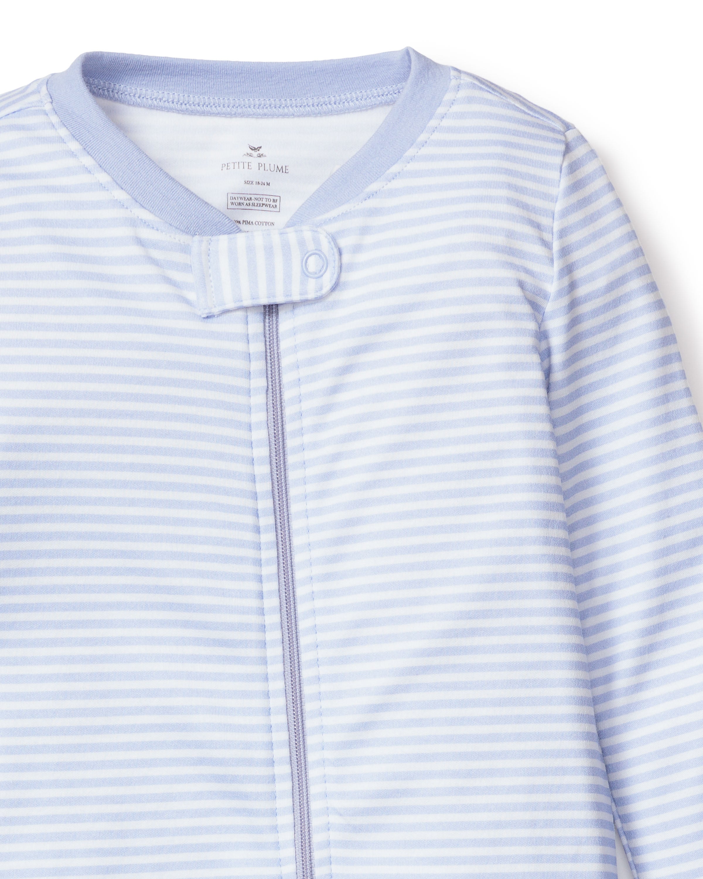 Petite Plumes Babys Pima Romper in Blue Stripes is crafted from 100% Pima cotton, featuring a light blue and white stripe design, front zipper, and top snap button. The soft fabric ensures comfort for infants.