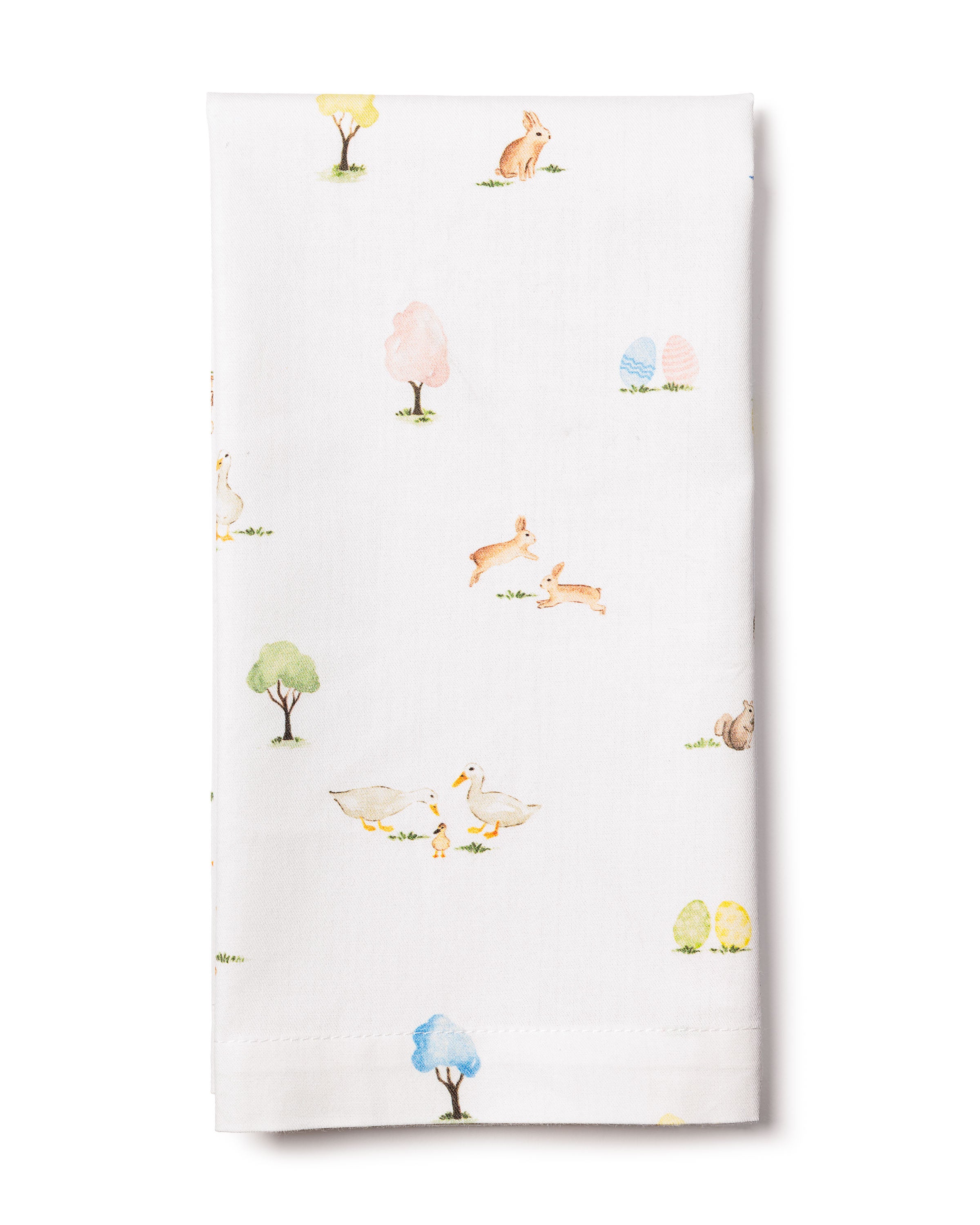 The Easter Gardens Table Linen by Petite Plume is a charming white tablecloth with pastel illustrations of rabbits, trees, ducks, and eggs. Made from 100% cotton, its simple artwork is spaced out to create a delightful festive tablescape.