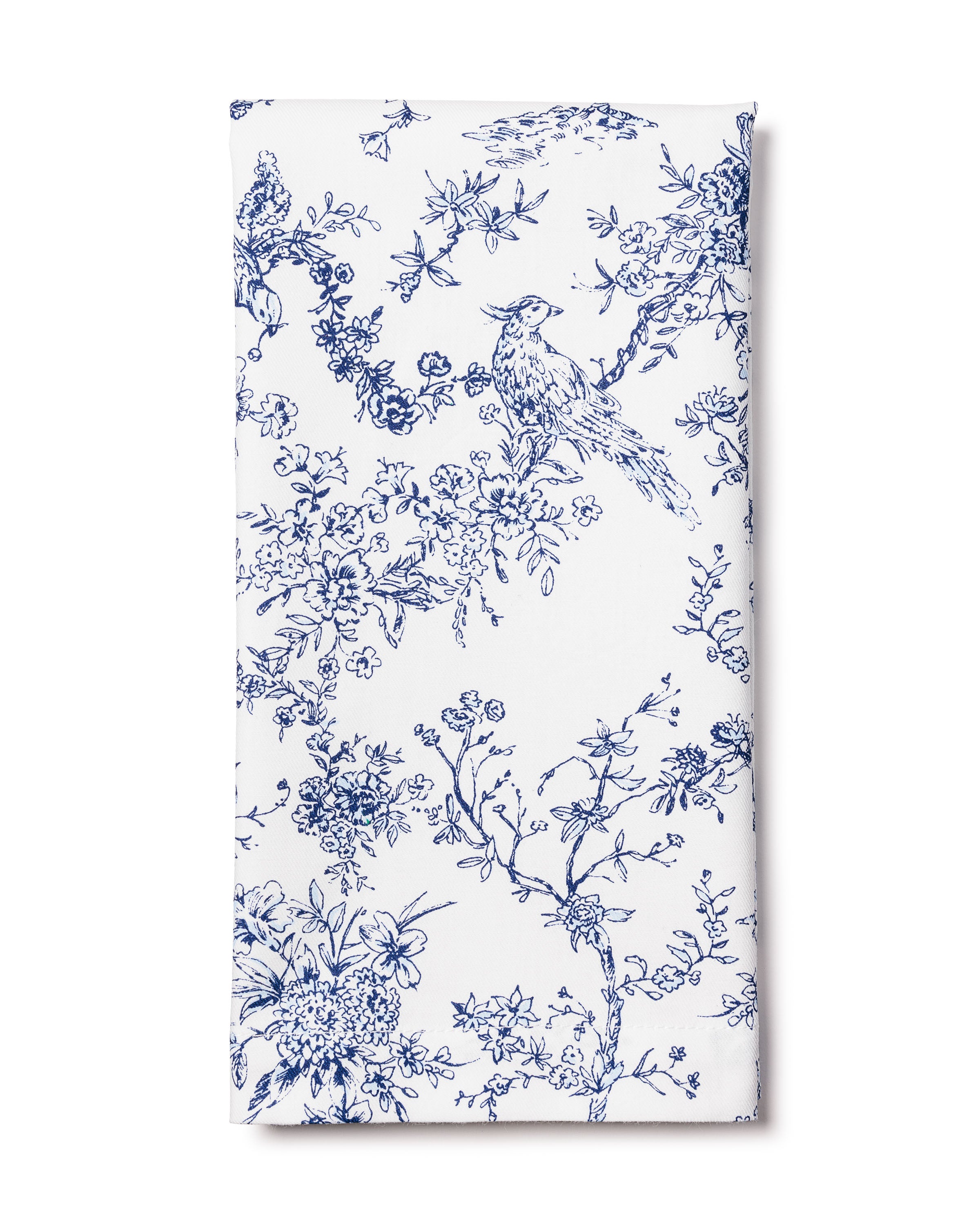 The Signature Twill Napkin in Timeless Toile by Petite Plume is crafted from white cotton, displaying an intricate blue toile de Jouy pattern with birds and flowering branches, ideal for adding a classic and vintage touch to elegant table linens.