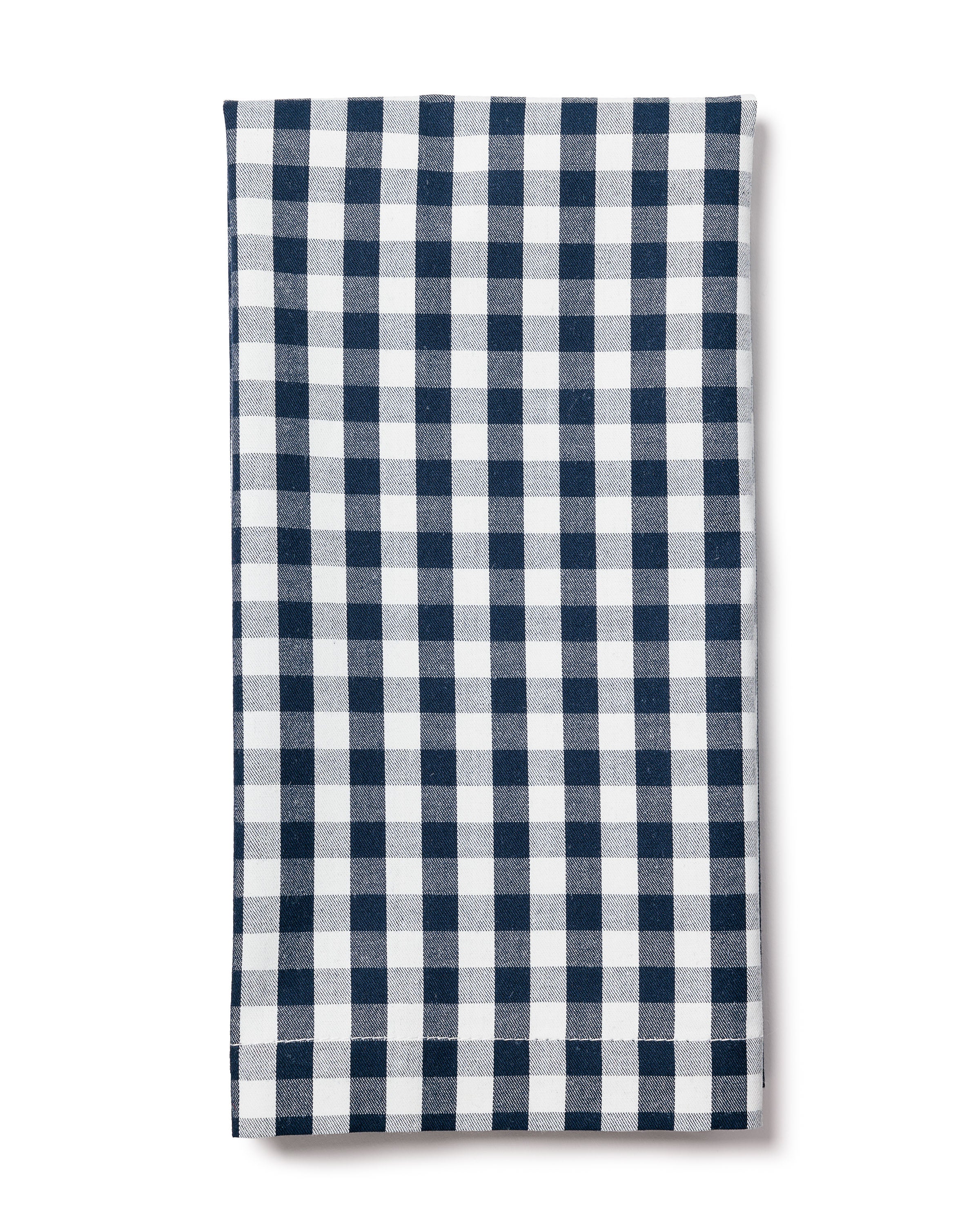 The Signature Twill Napkins in Navy Gingham by Petite Plume are neatly folded against a plain white background. Crafted from 100% cotton, they add charm to your festive tablescape or enrich your stylish table linens collection.