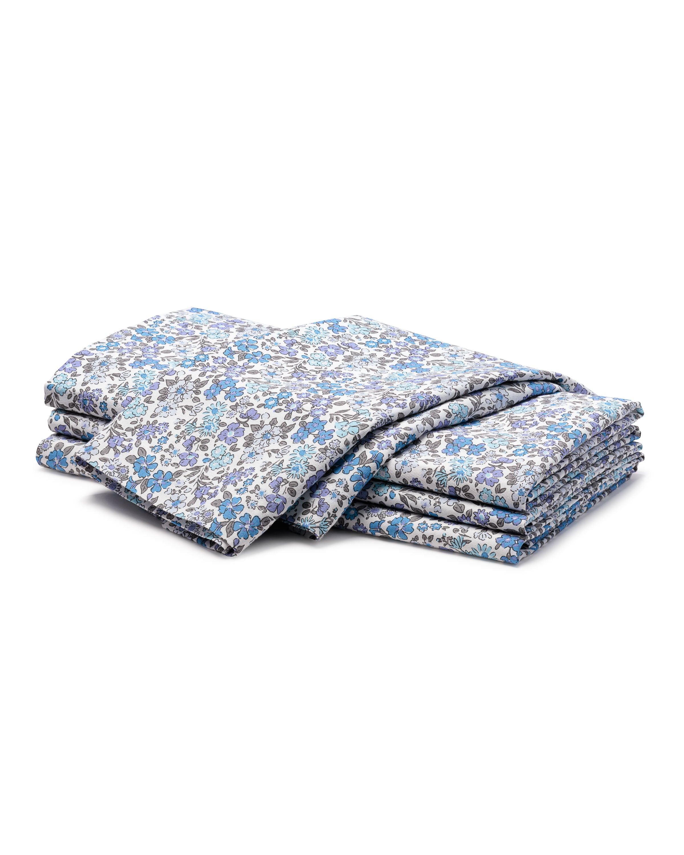 A folded quilt with detailed Petite Plume prints features a floral pattern in blue, white, and gray on a pristine background. Crafted from 100% cotton, it displays small flowers and leaves for ornamental charm.