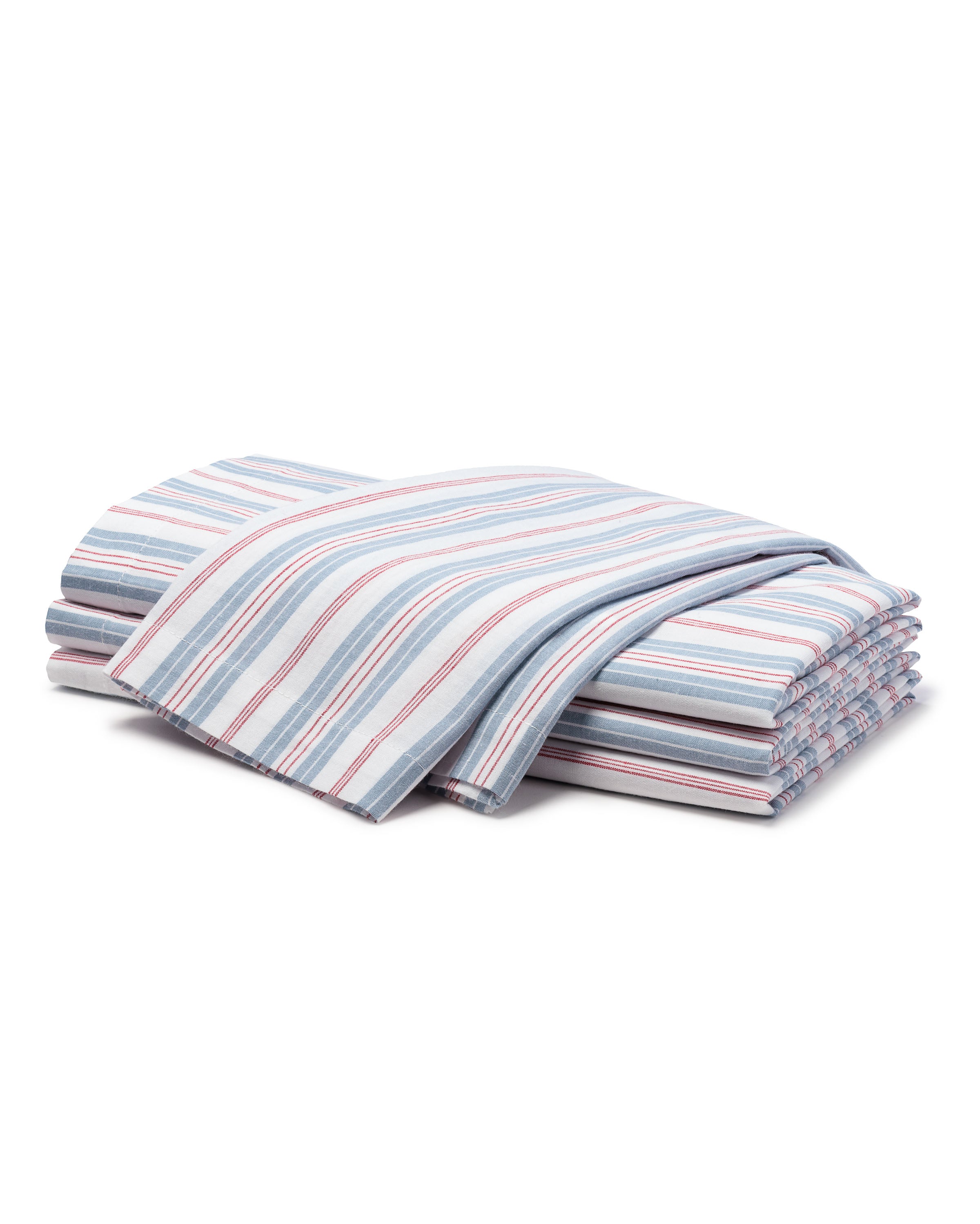 A folded set of Signature Twill Napkins by Petite Plume featuring Vintage French Stripes in blue, red, and white on a crisp white background.