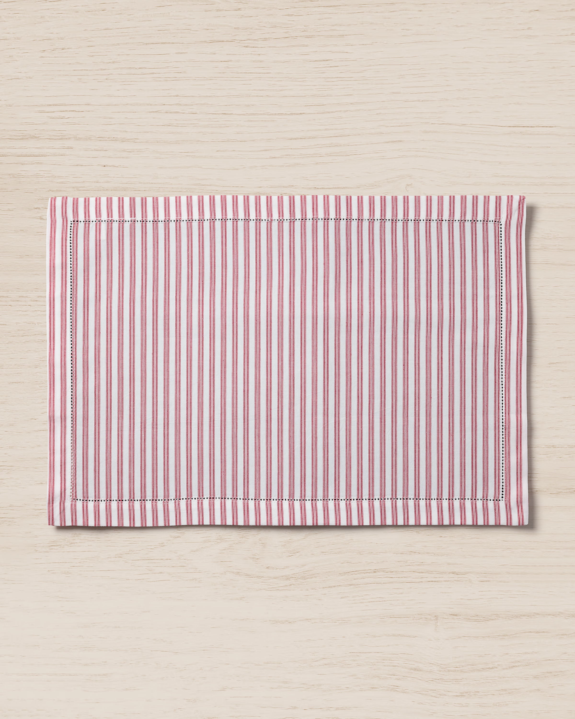 The Signature Twill Placemats in Antique Red Ticking by Petite Plume showcase a stylish rectangle design with red and white stripes, perfect for enhancing your table linens.