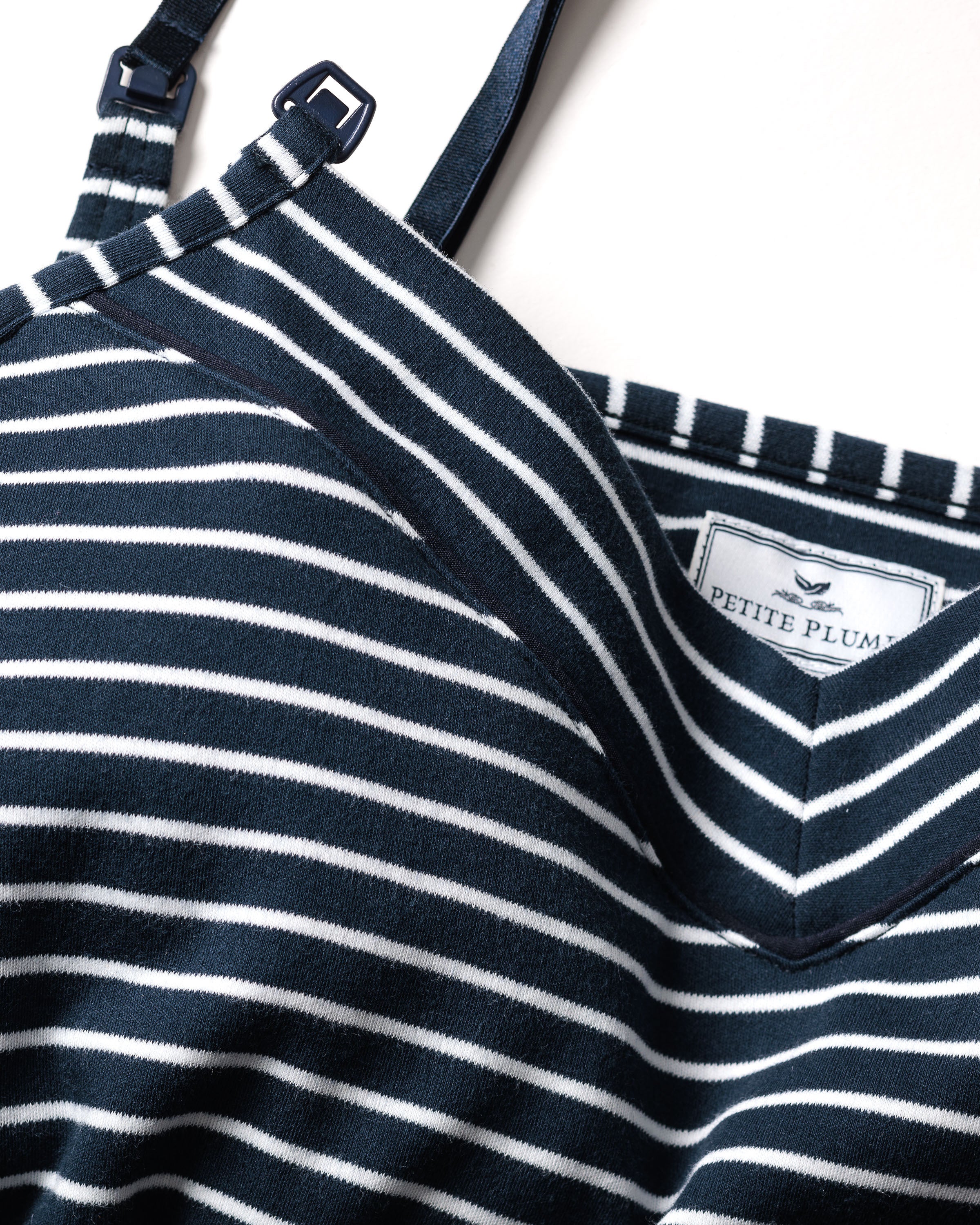 Close-up of a navy blue and white striped fabric labeled Petite Plume, featuring diagonal V-shaped stripes that indicate its from the Womens Pima Maternity Nightgown in Navy Stripe, offering comfort ideal for nursing mothers.