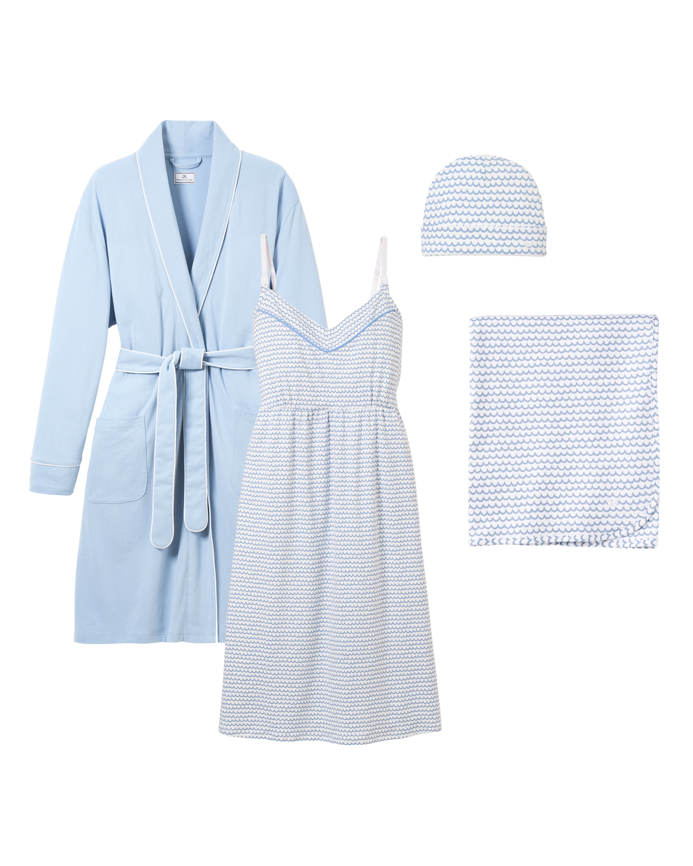 The Hospital Stay Luxe Set by Petite Plume includes a periwinkle robe with waist tie, paired with a sleeveless La Mer patterned dress. Complete with a matching cap and folded blanket, its elegantly arranged for gifting and makes an ideal hospital stay essential.