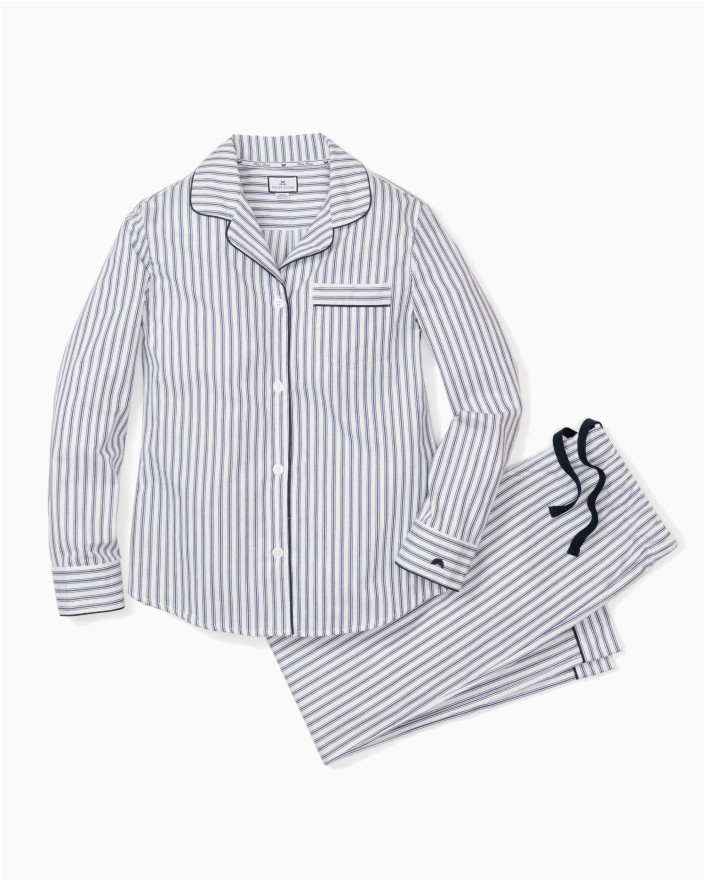 A matching set of long-sleeve, button-up pajamas with grey and white vertical stripes, featuring a chest pocket and dark piping details, laid flat on a white background.