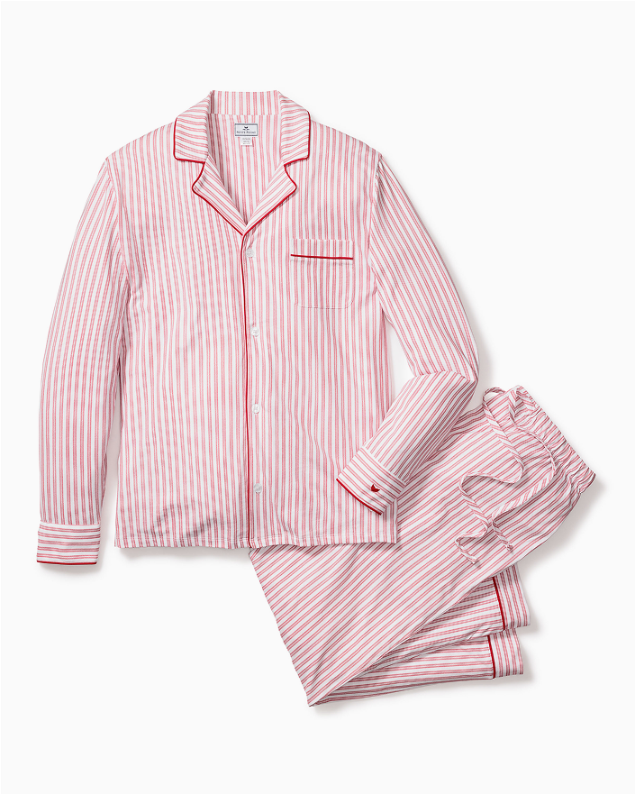 A matching set of pink and white striped pajamas with a long-sleeve button-up top and drawstring pants, featuring red piping on the collar, cuffs, and pocket.