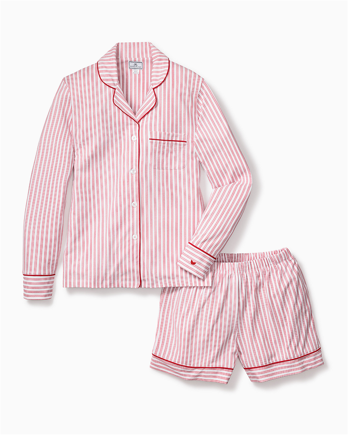 A matching pajama set with a long-sleeve, button-up top and shorts, both featuring red and white vertical stripes and red piping on the edges.