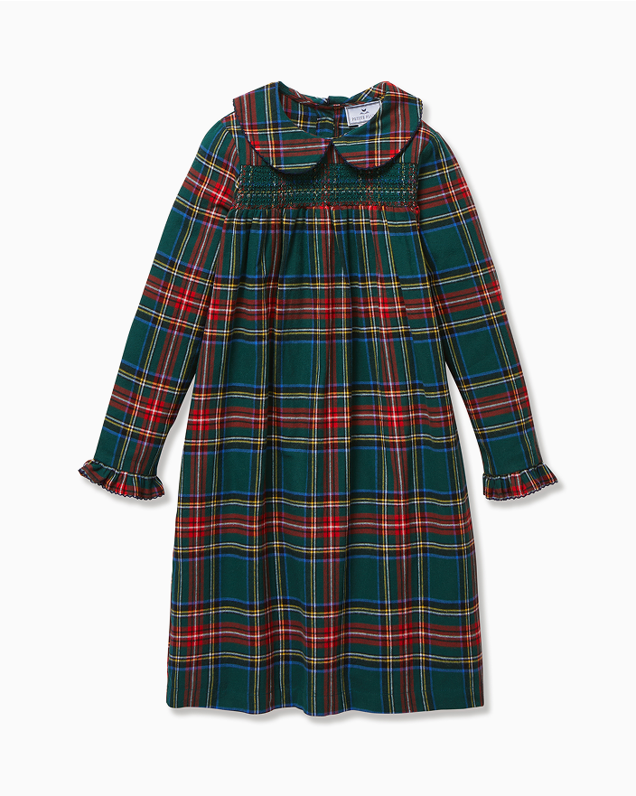 A long-sleeved, knee-length dress with a green, red, and yellow plaid pattern, featuring a Peter Pan collar, smocked chest, and ruffled cuffs.