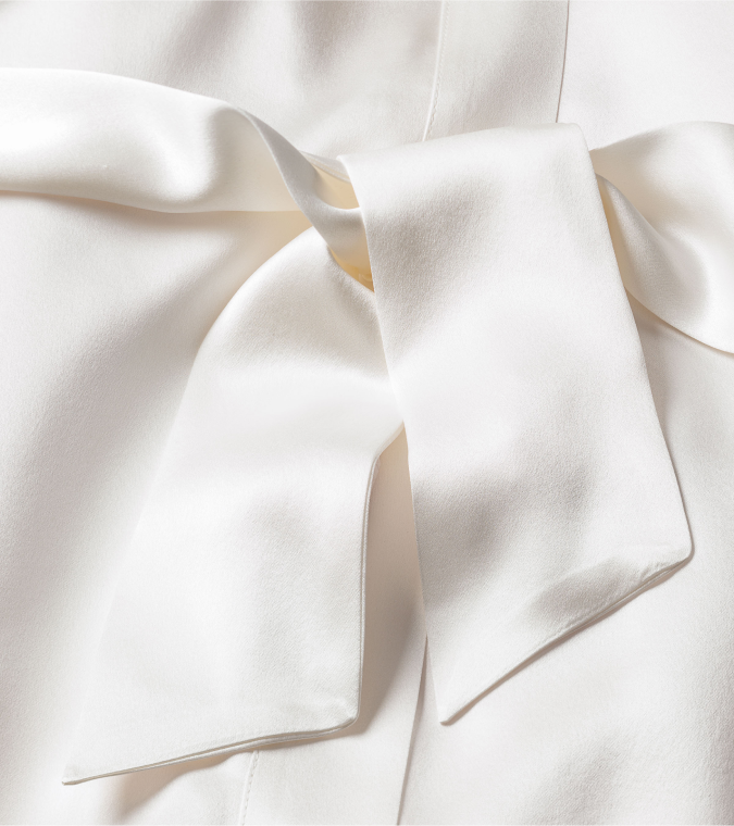 Close up of white silk robe with sash tied in a bow