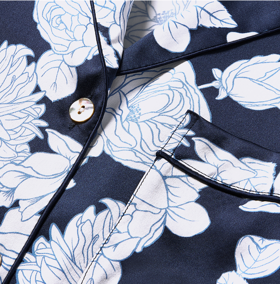Close up of White flowers on Navy pajama top
