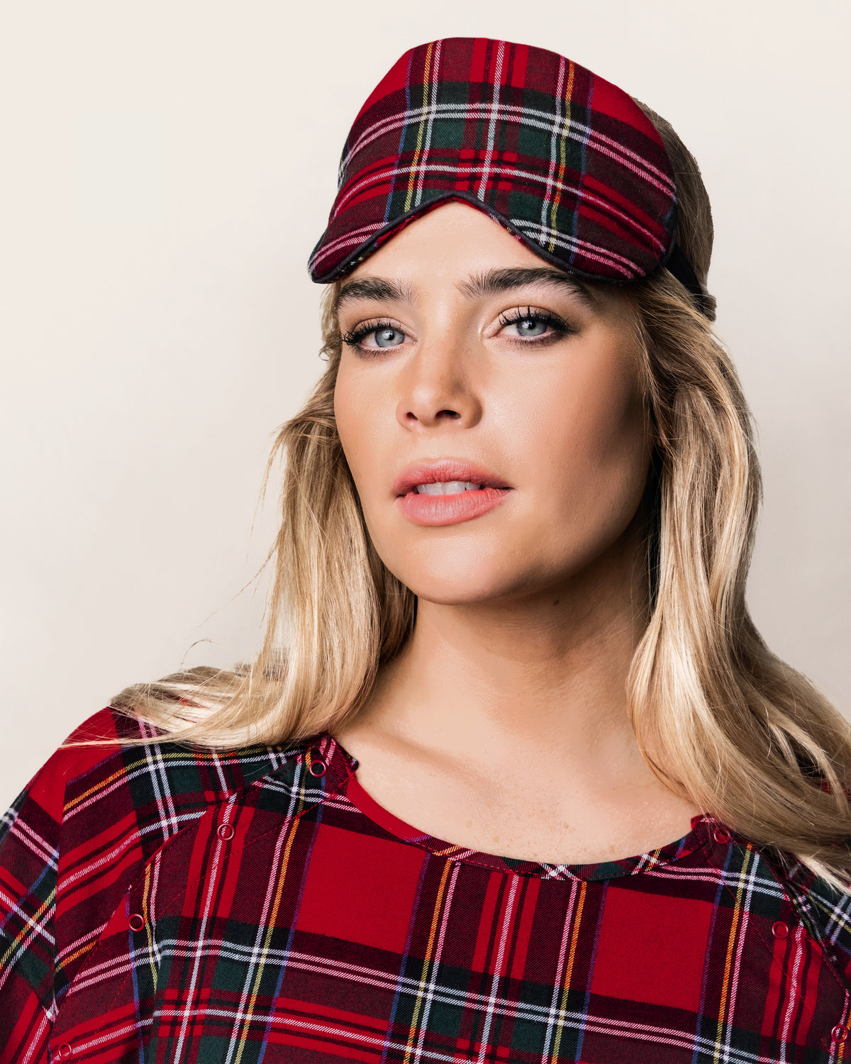 The Adult's Brushed Twill Sleep Mask in Imperial Tartan features a red plaid design with green, black, and white stripes and a white elastic strap, shown on a white background.
