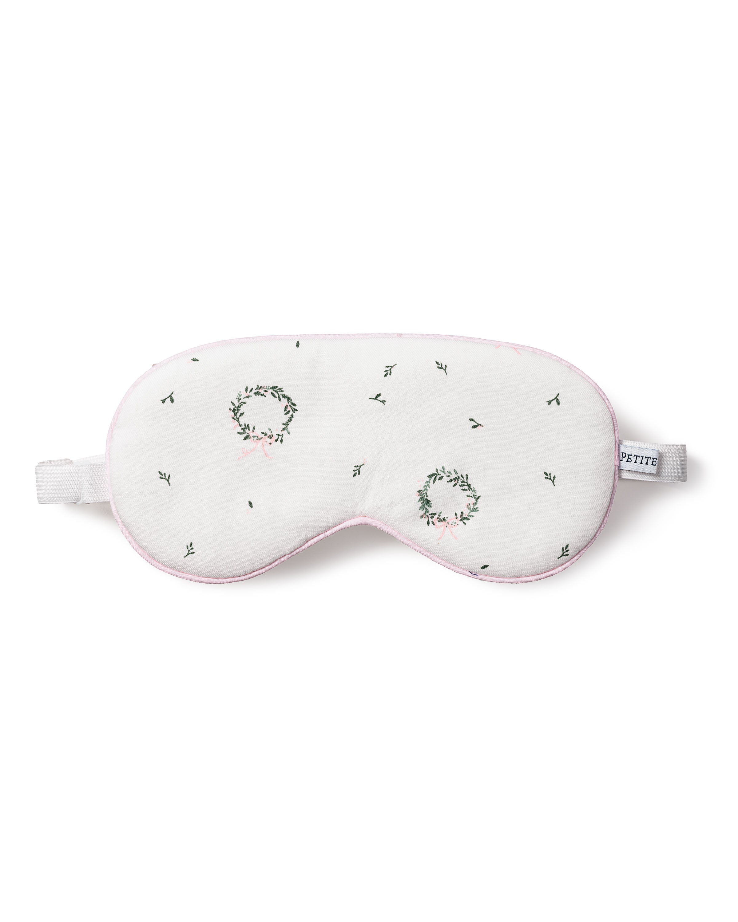 The Petite Plume Adults Twill Sleep Mask in Somerset Wreath features white twill, embroidered green and pink wreaths, black stitching, a white elastic strap, soft pink trim, and a PETITE tag—perfect for matching or gifting.