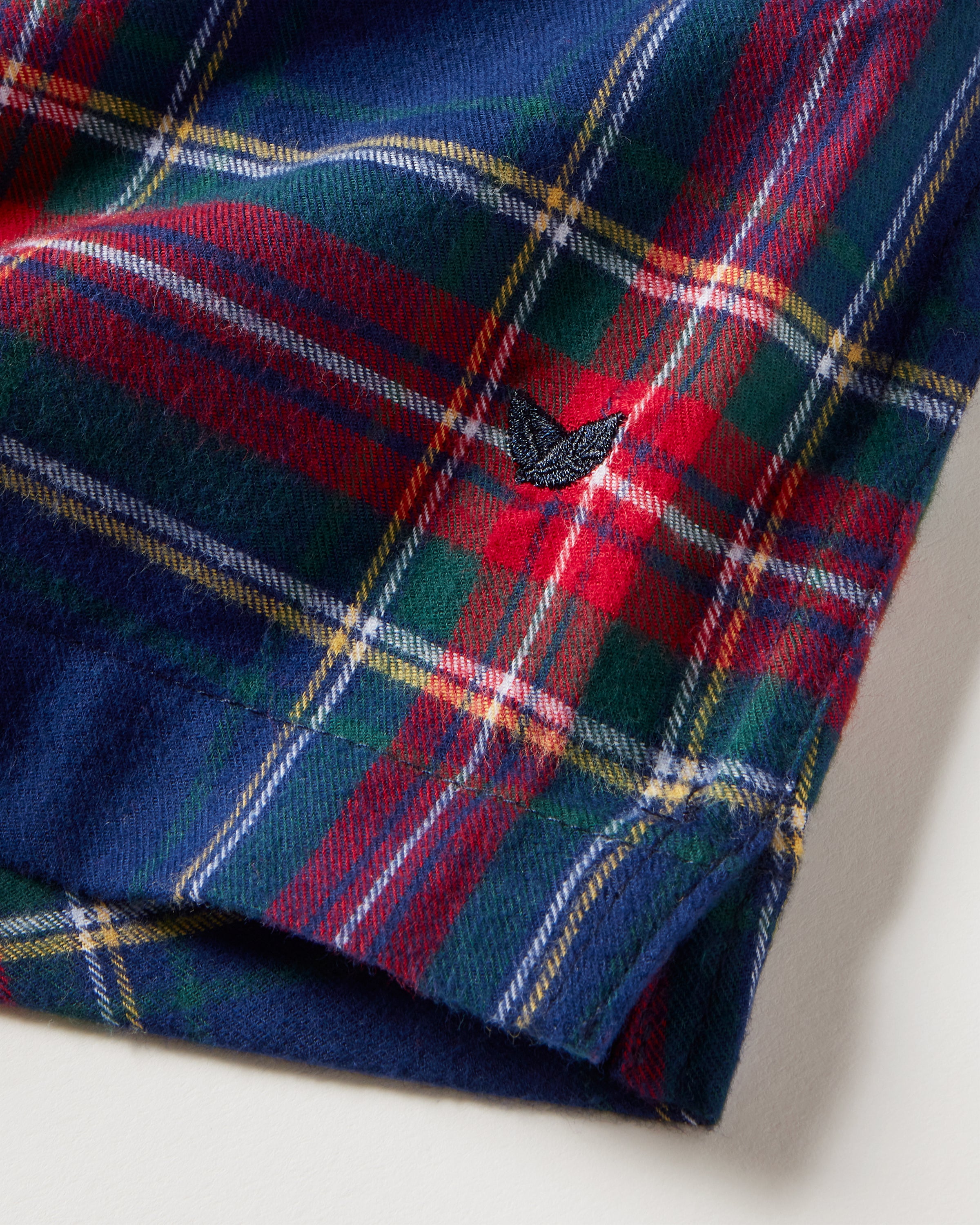 A close-up of Petite Plume Mens Twill 3 Pack Boxers in Windsor Tartan—woven cotton twill featuring red, green, and blue plaid with white and yellow stripes and a small embroidered bird logo.