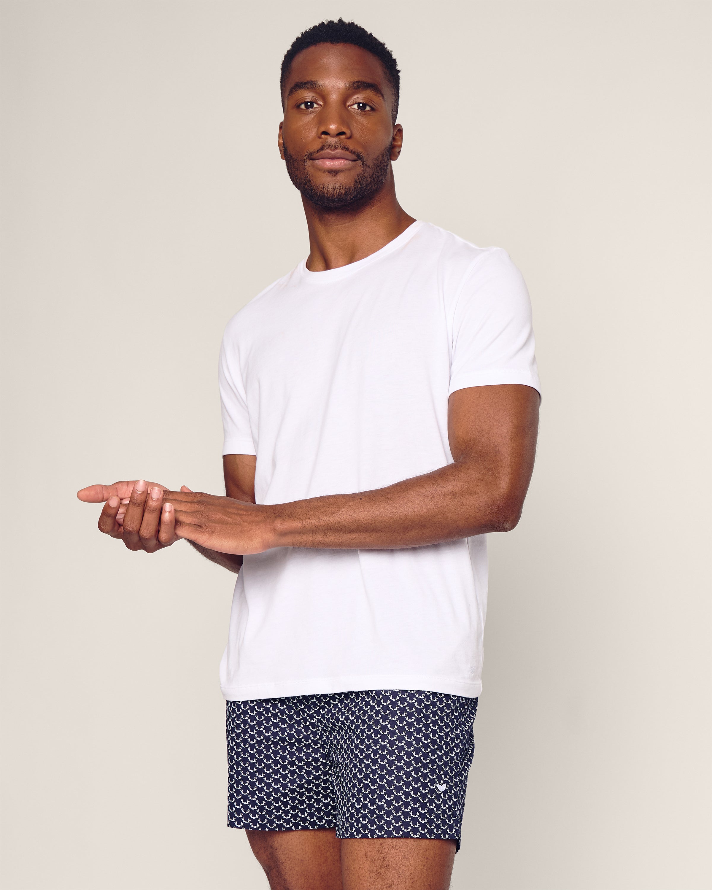 A man stands against a plain background wearing Petite Plume Mens Twill 3 Pack Boxers in Windsor Tartan, with his hands together at waist height and a neutral expression.