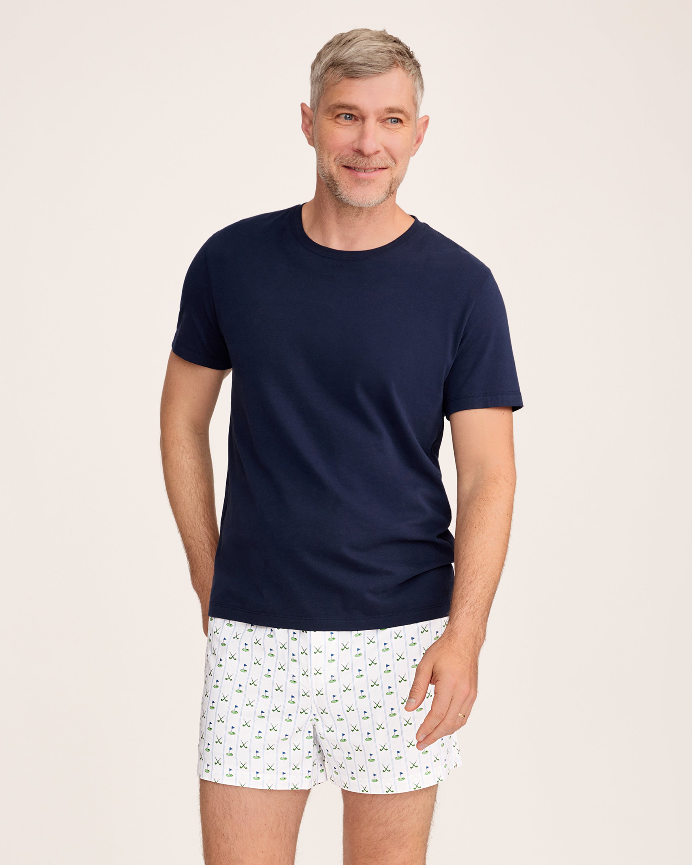 The Men's Twill 3 Pack Boxers in Fairway Stripe includes three pairs: one with blue and white vertical stripes, one solid white, and one white featuring a green and blue golf club pattern.