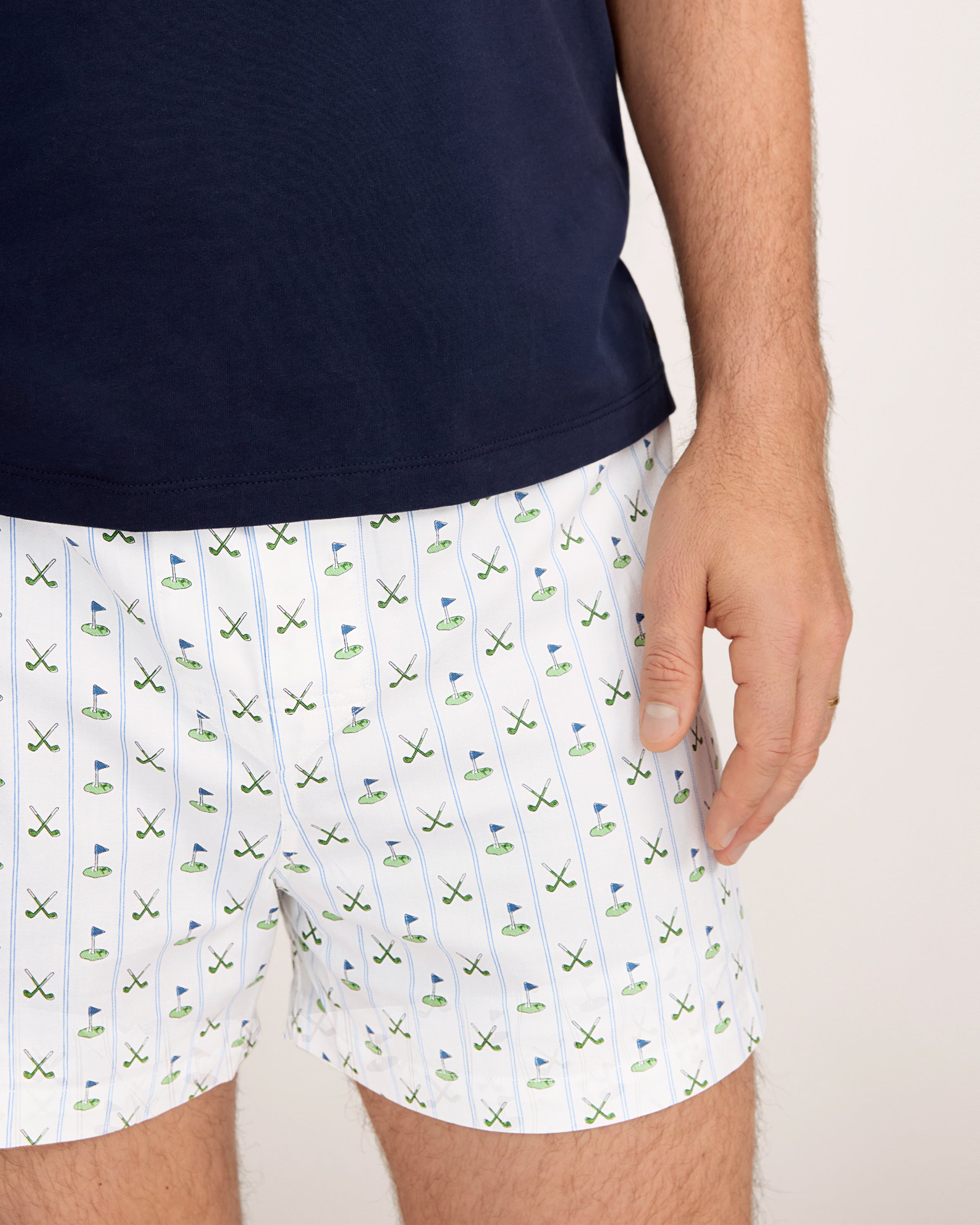 The Men's Twill 3 Pack Boxers in Fairway Stripe includes three pairs: one with blue and white vertical stripes, one solid white, and one white featuring a green and blue golf club pattern.