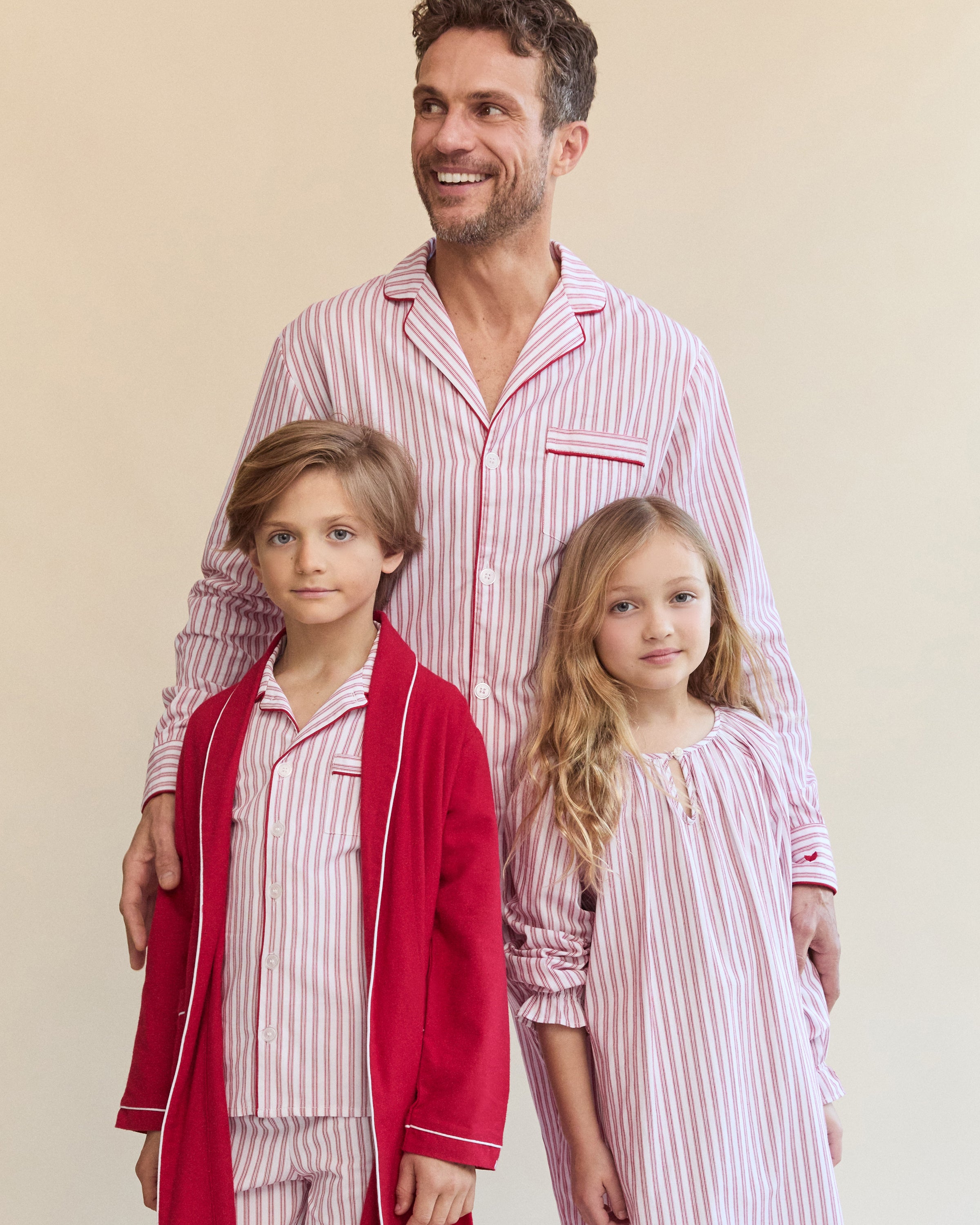 Close-up of Petite Plumes Mens Twill Pajama Set in Antique Red Ticking, featuring pink and white vertical stripes, a collar, a pocket with matching trim, and a single white button. Perfect for cozy relaxation.
