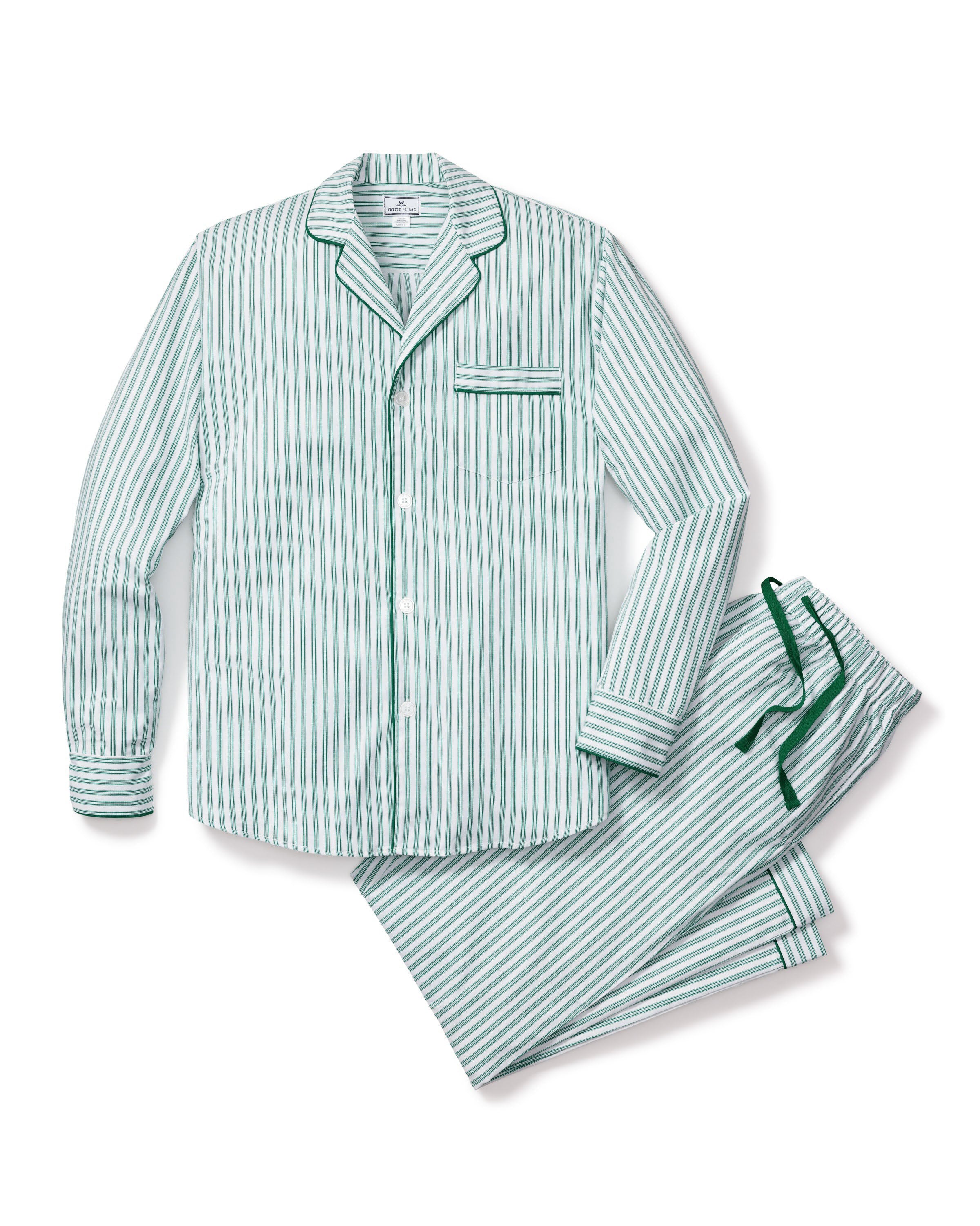 The Mens Twill Pajama Set in Emerald Ticking by Petite Plume features a close-up view of striped cotton fabric with vertical light blue and white lines, a French ticking pattern, green piping edges, three white buttons, and a right-side pocket.