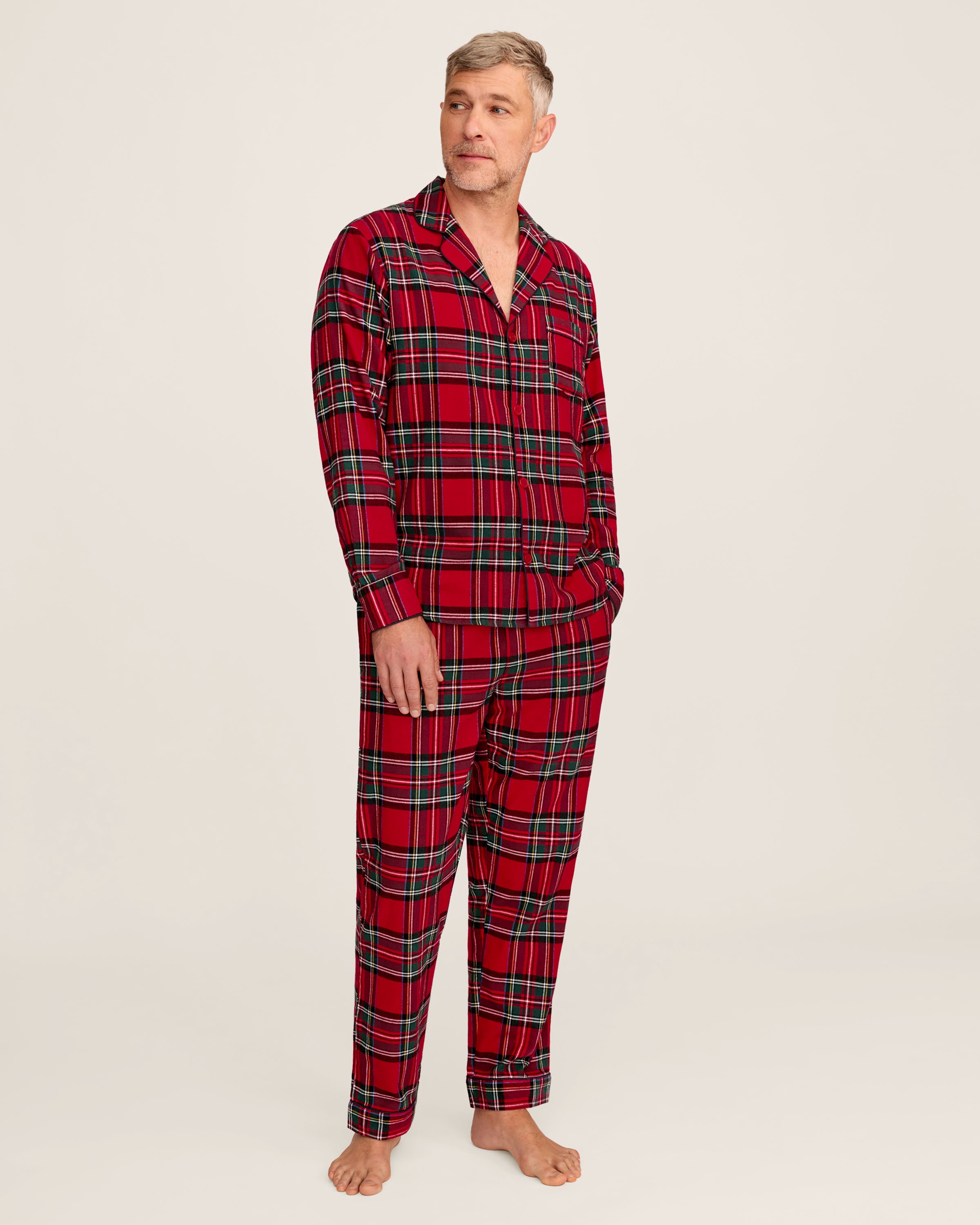 The Men's Brushed Twill Pajama Set in Imperial Tartan features a red plaid design with green, white, and black stripes, a button-up long-sleeve top with a chest pocket, and matching pants, displayed neatly on a white background.