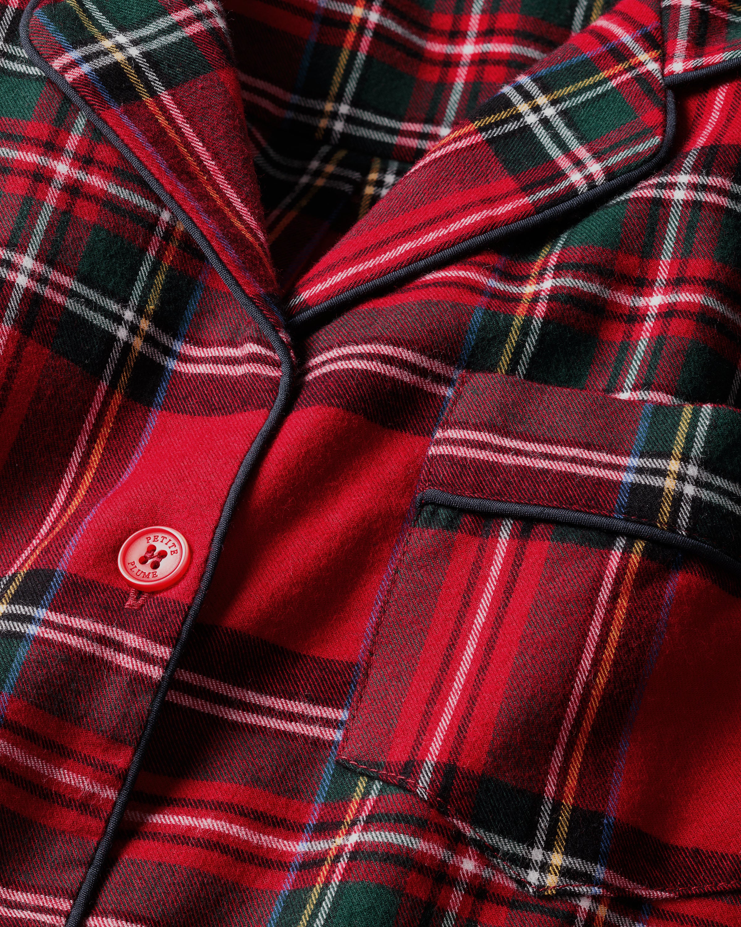 The Men's Brushed Twill Pajama Set in Imperial Tartan features a red plaid design with green, white, and black stripes, a button-up long-sleeve top with a chest pocket, and matching pants, displayed neatly on a white background.