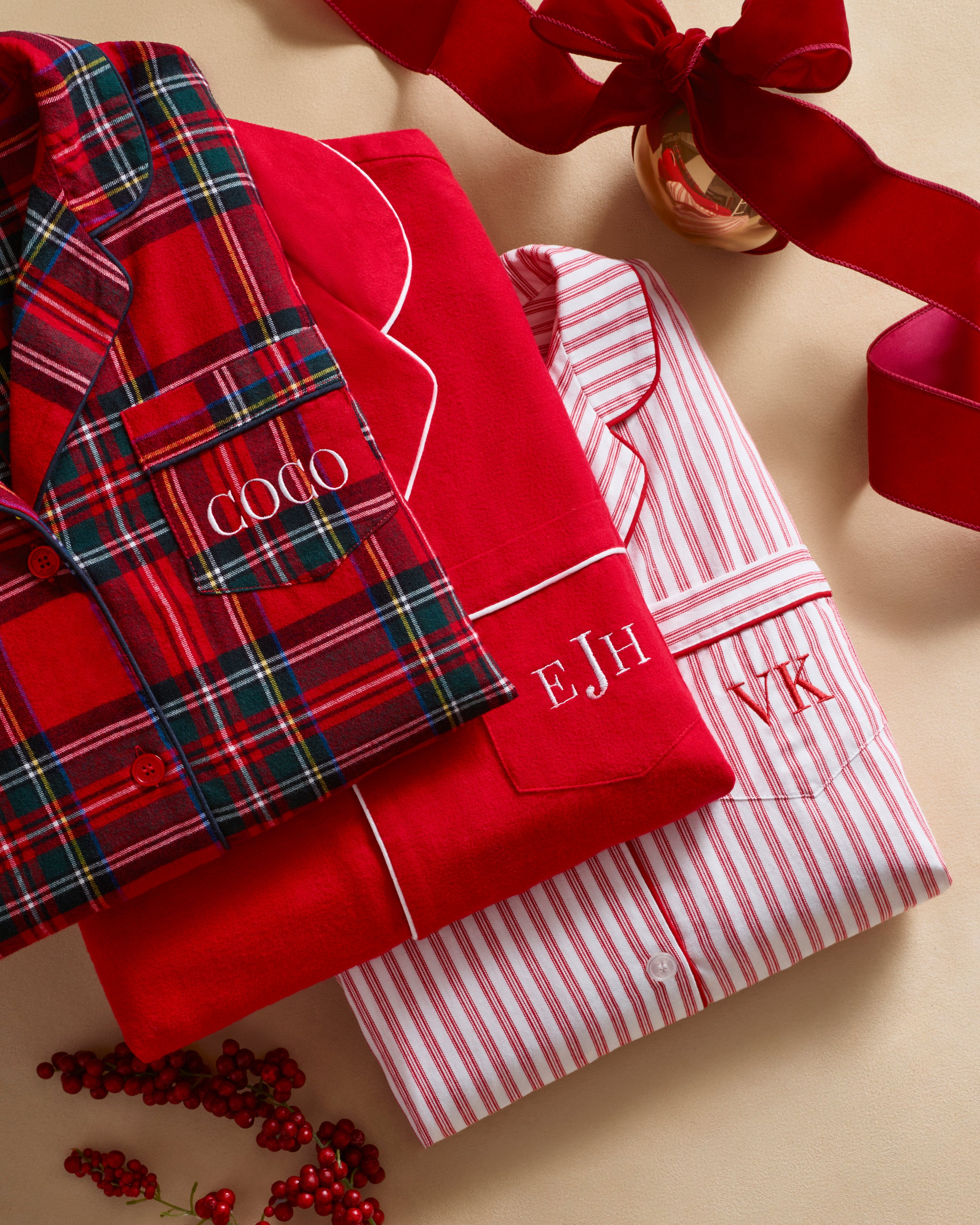 The Men's Brushed Twill Pajama Set in Imperial Tartan features a red plaid design with green, white, and black stripes, a button-up long-sleeve top with a chest pocket, and matching pants, displayed neatly on a white background.