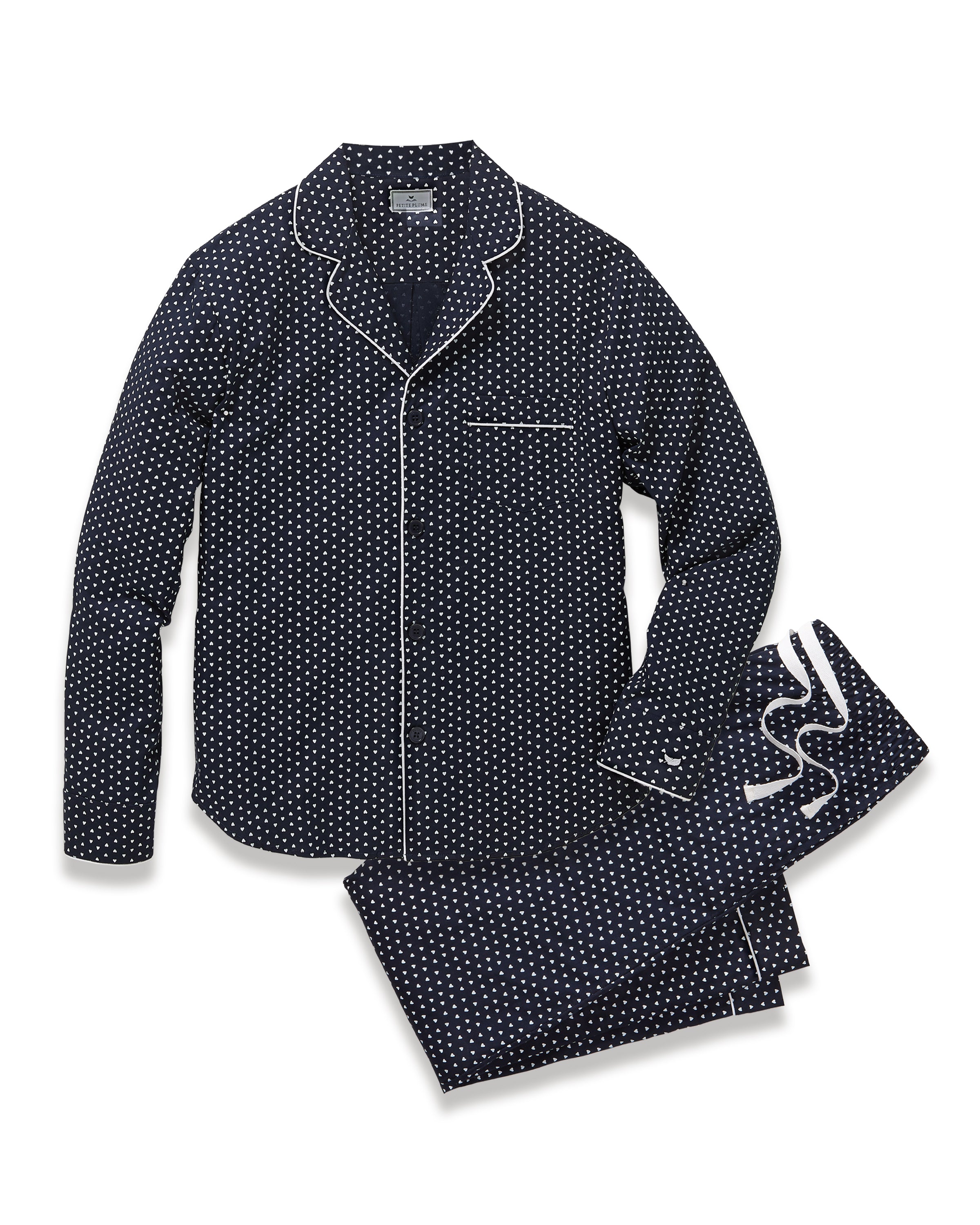 The Men's Twill Pajama Set in Midnight Hearts features a long-sleeve button-up top and pants, both navy blue with a small white polka dot pattern and white piping details.