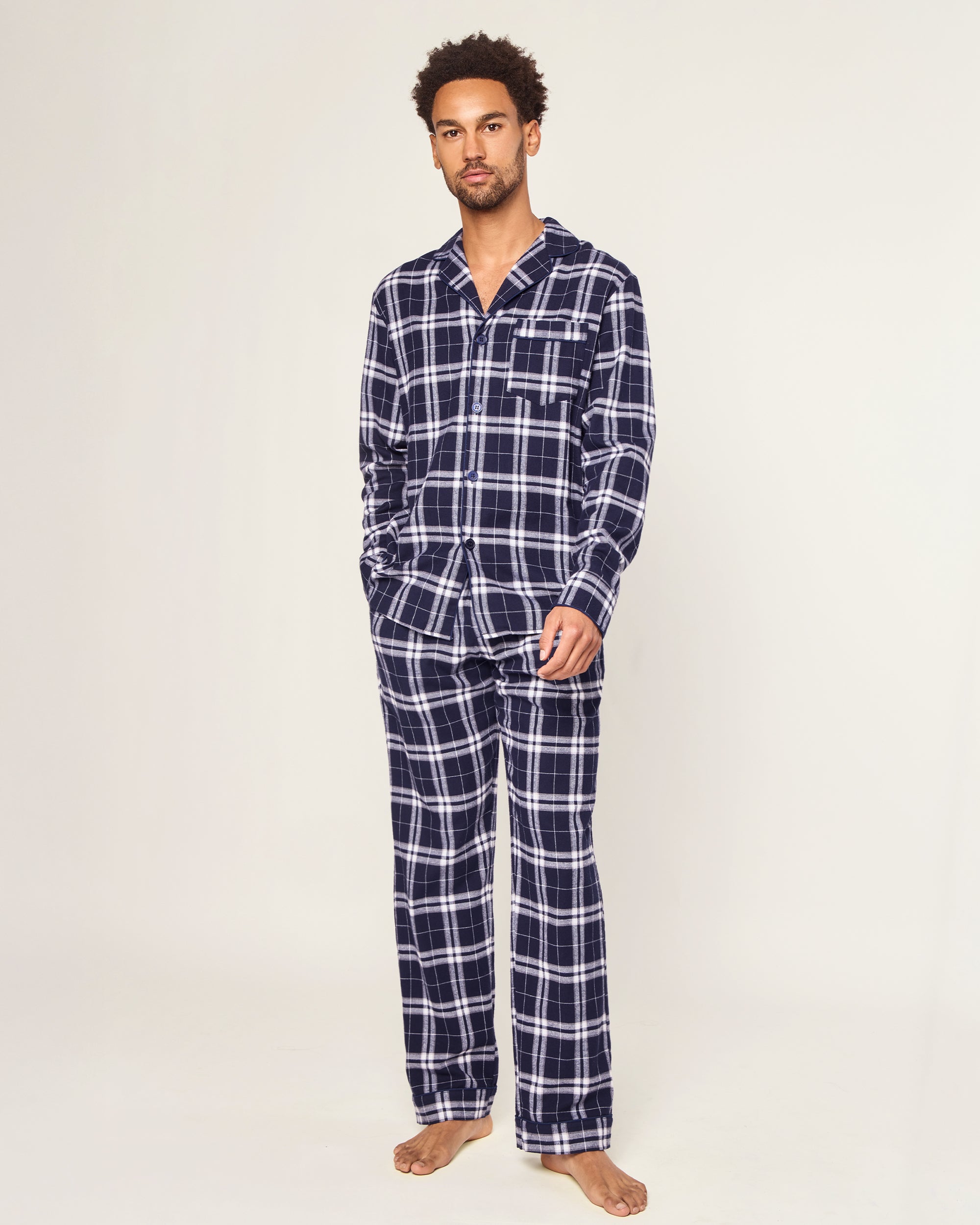 The Men's Brushed Twill Pajama Set in Oxford Tartan includes a two-piece navy and white plaid design with a long-sleeved button-up shirt featuring a chest pocket and matching drawstring pants.