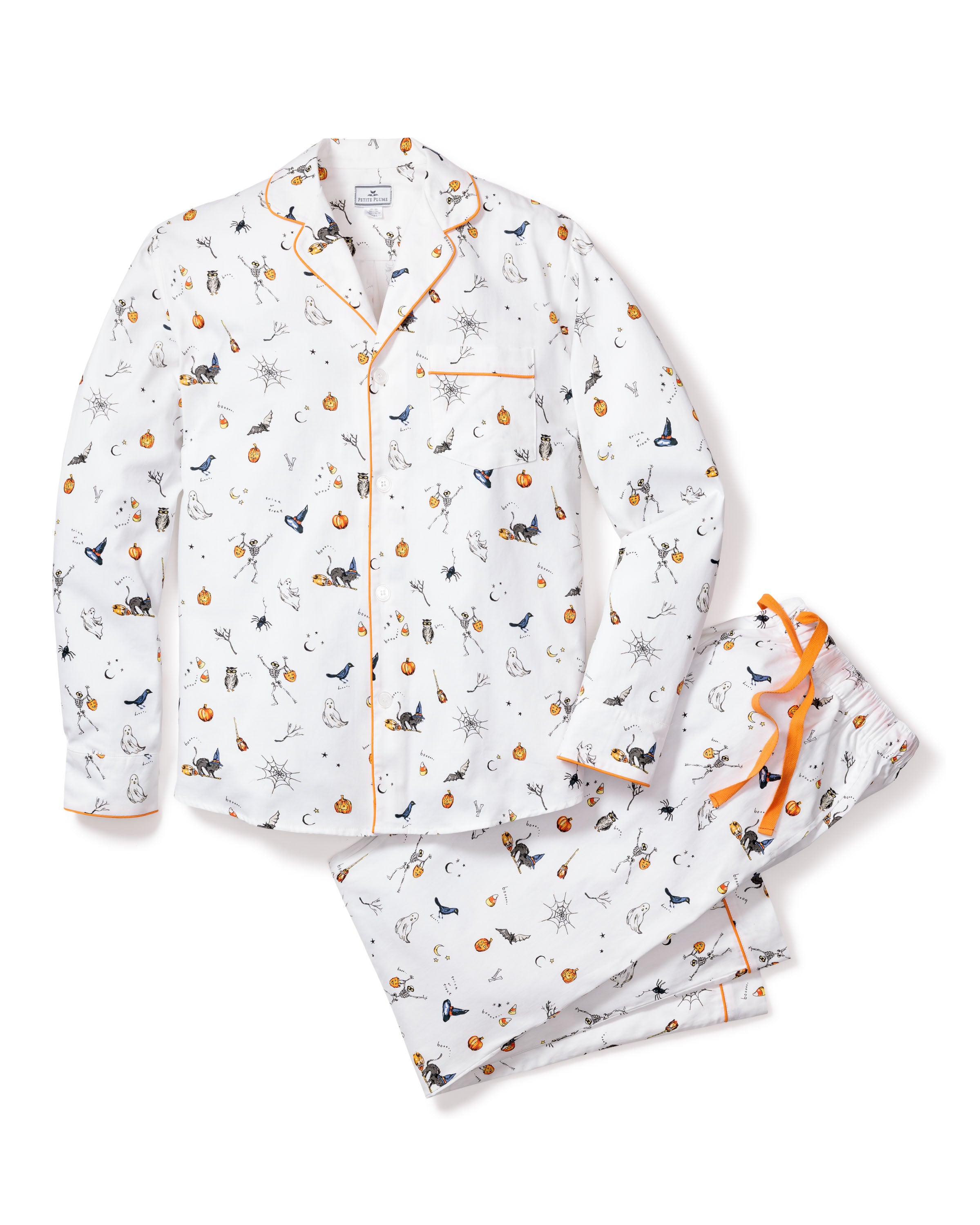 The Mens Twill Pajama Set in Trick or Treat by Petite Plume is made of premium cotton, featuring long sleeves and pants with a playful Halloween print of pumpkins, black cats, spiders, and bats, finished with orange trim and a decorative bow for a festive flair.