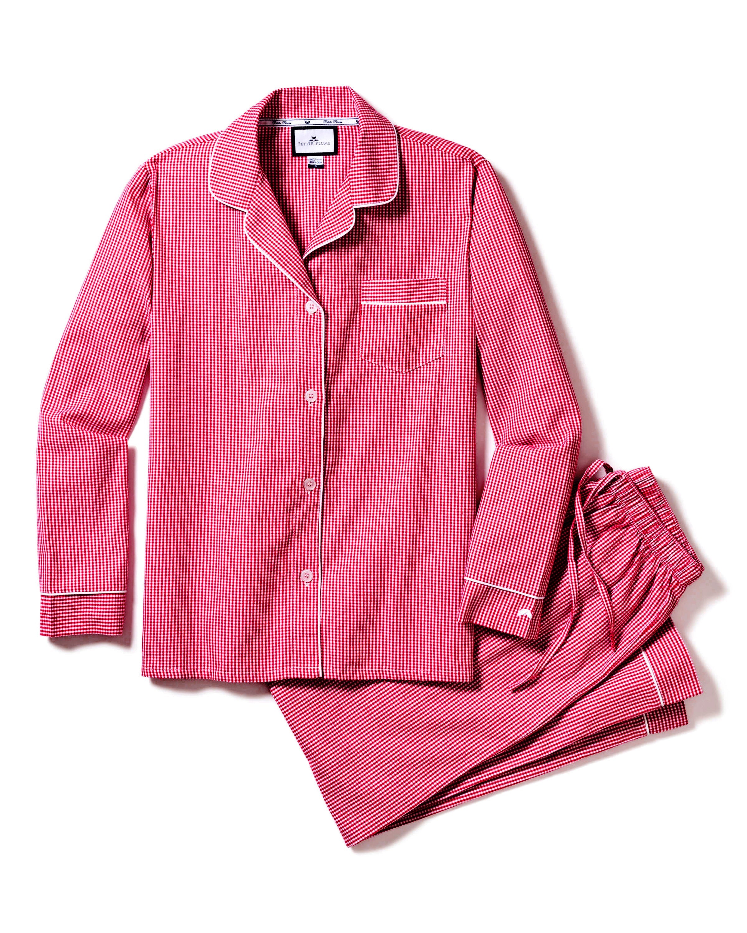 The Womens Flannel Pajama Set in Red Mini Gingham by Petite Plume features a long-sleeve button-up top with a chest pocket and elegant white piping, perfectly paired with matching pants for timeless luxury.