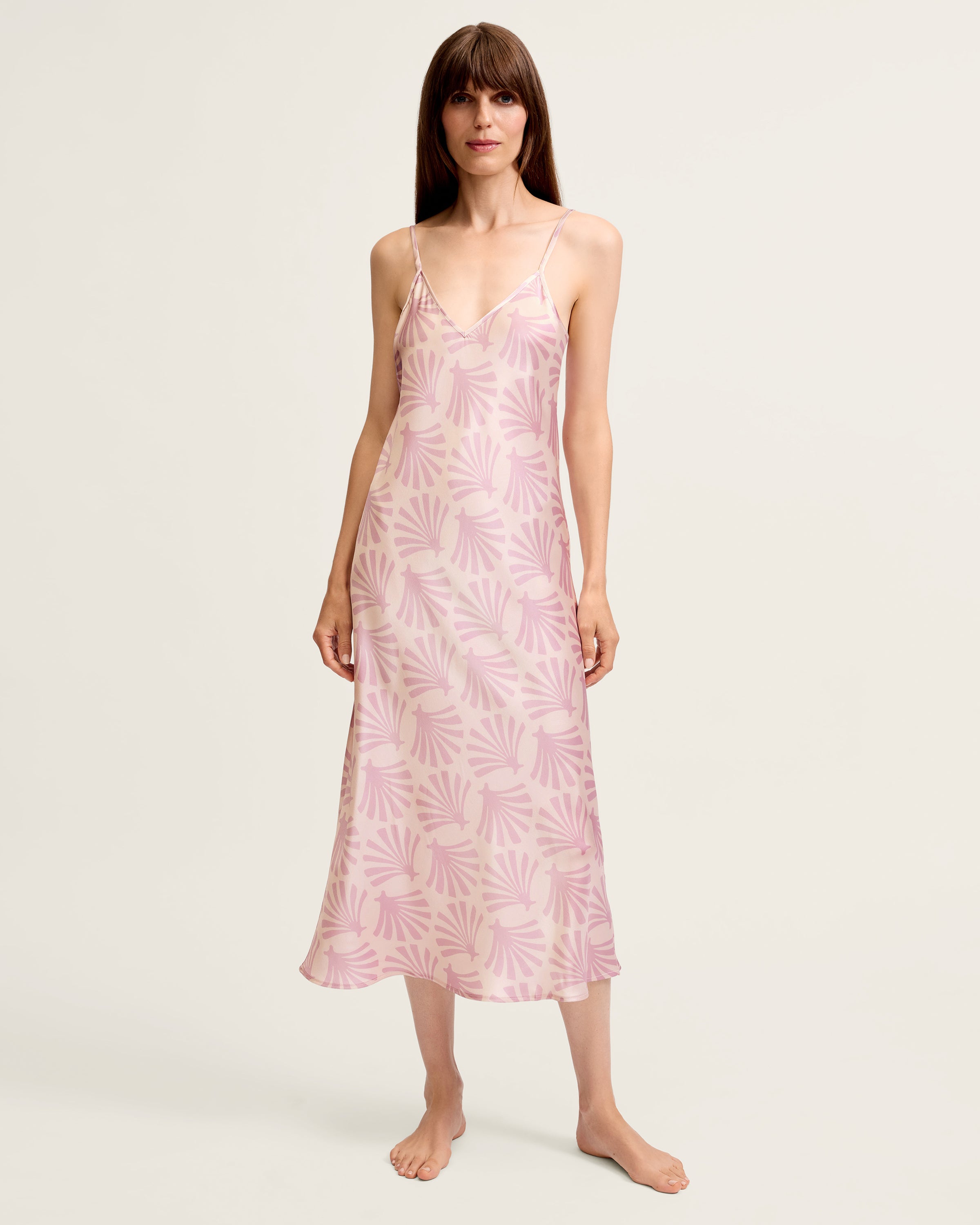 The Women's Silk Cosette Nightgown in Blush Tide is a light pink sleeveless slip dress with thin straps and a subtle darker pink leaf pattern, shown laid flat on a white background.