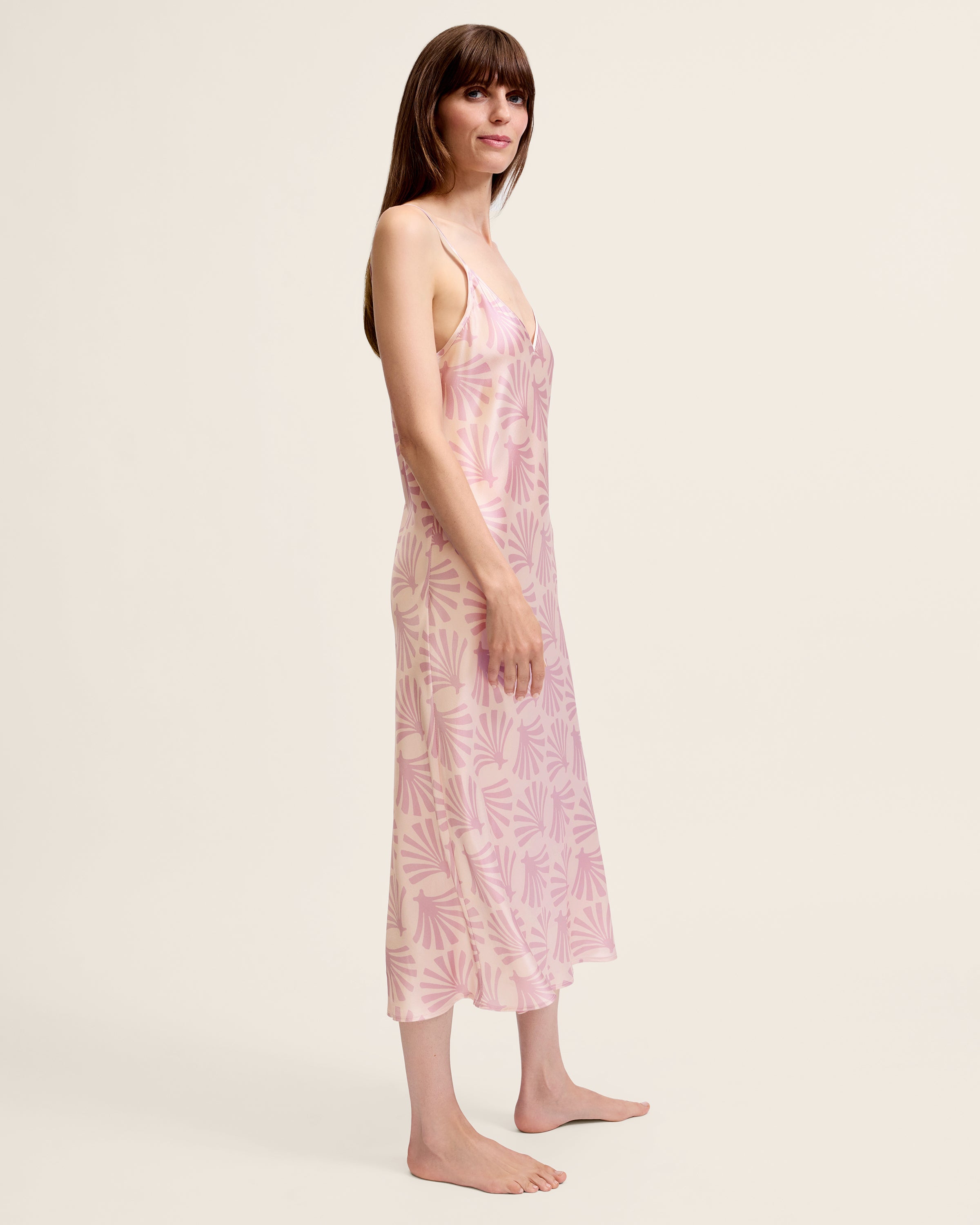 The Women's Silk Cosette Nightgown in Blush Tide is a light pink sleeveless slip dress with thin straps and a subtle darker pink leaf pattern, shown laid flat on a white background.