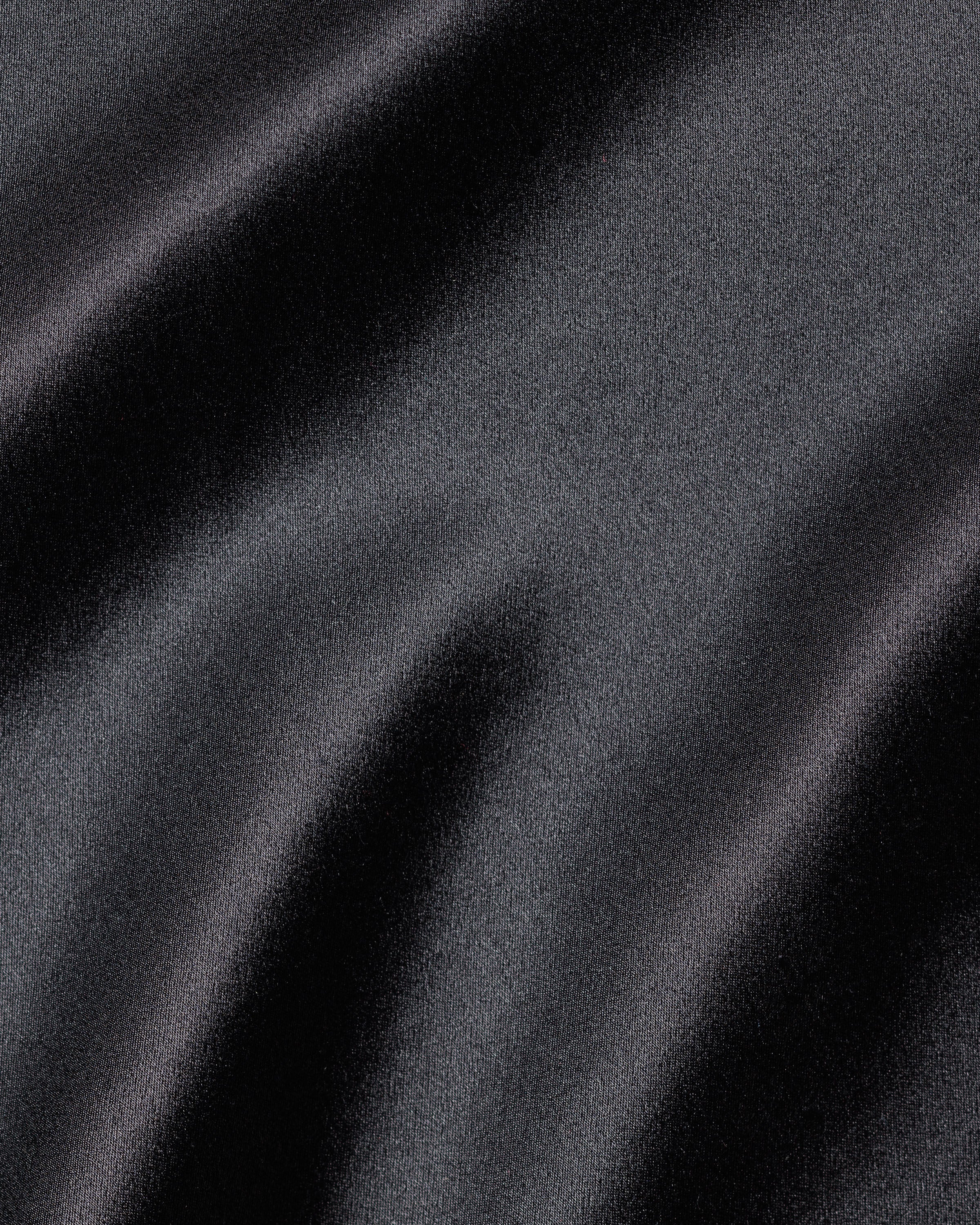 The Womens Silk Lace Slip Dress in Black by Petite Plume features silky, smooth fabric with dark gray hues and gentle waves, creating a soft play of light and shadow for luxurious sleepwear.