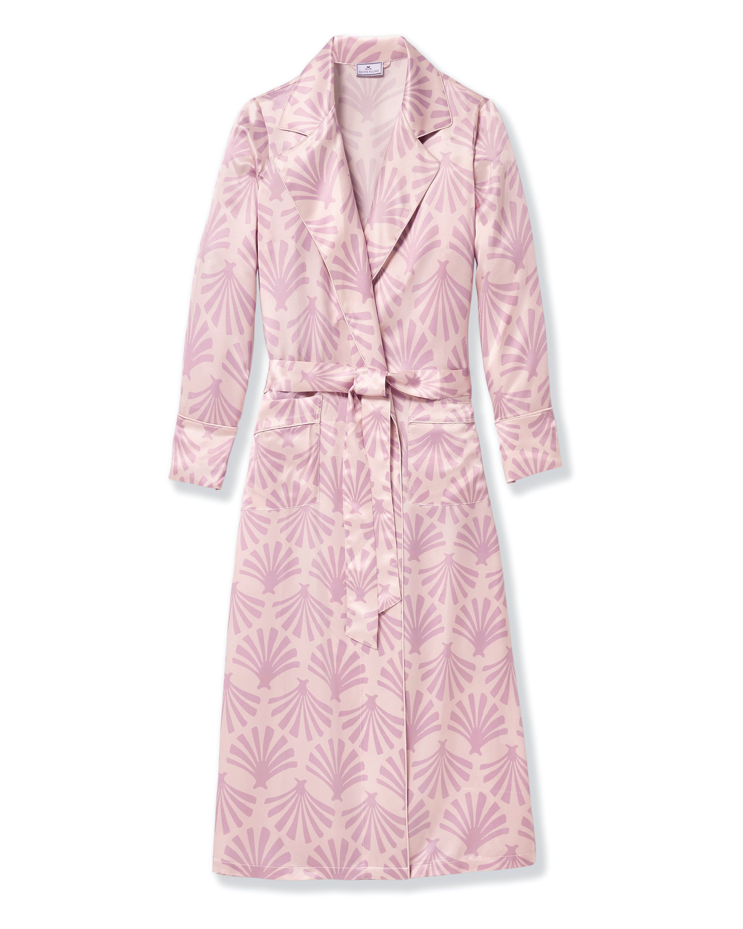The Women's Silk Robe in Blush Tide features a light pink hue with a darker pink geometric pattern, notched collar, long sleeves, and a matching waist belt.