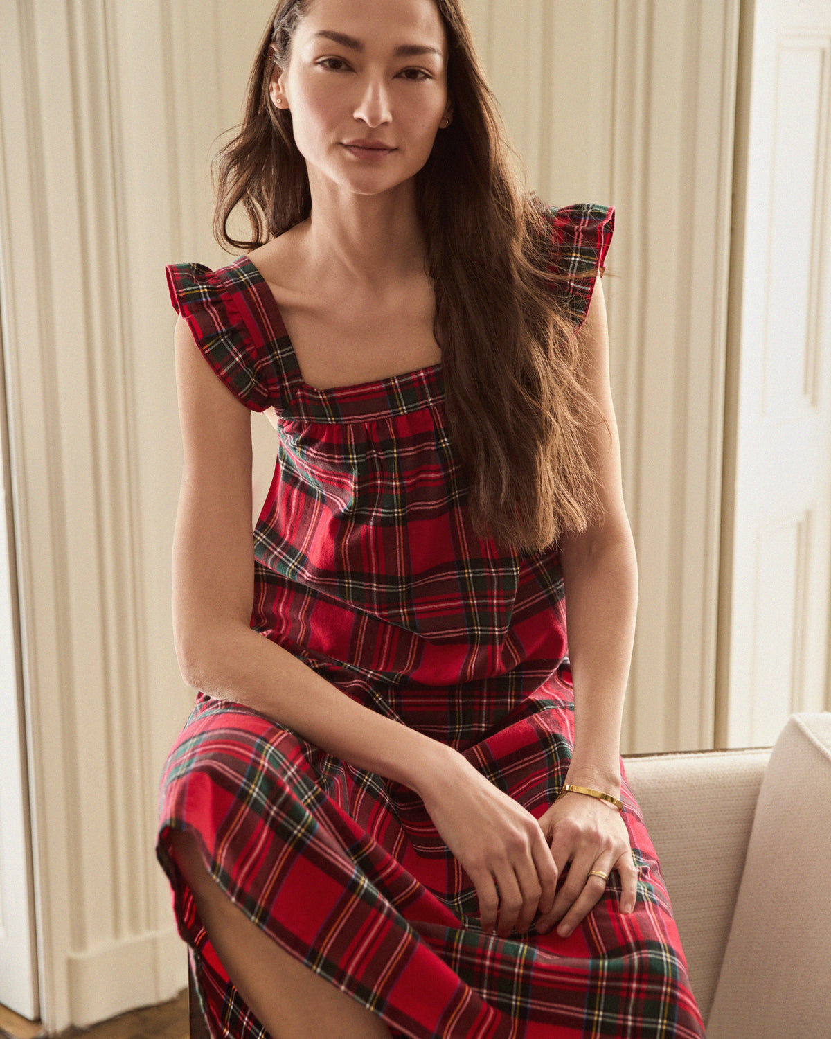 The Women's Brushed Twill Clara Nightgown in Imperial Tartan features a sleeveless red plaid design with green, yellow, and white stripes, ruffled shoulder straps, and a loose gathered bodice for a festive holiday look.